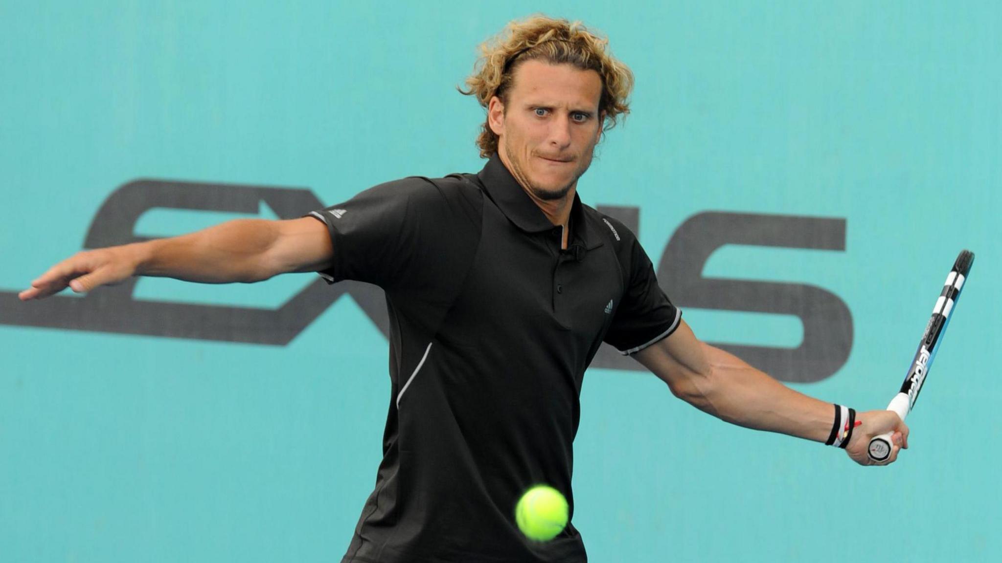 Diego Forlan hits a forehand return 