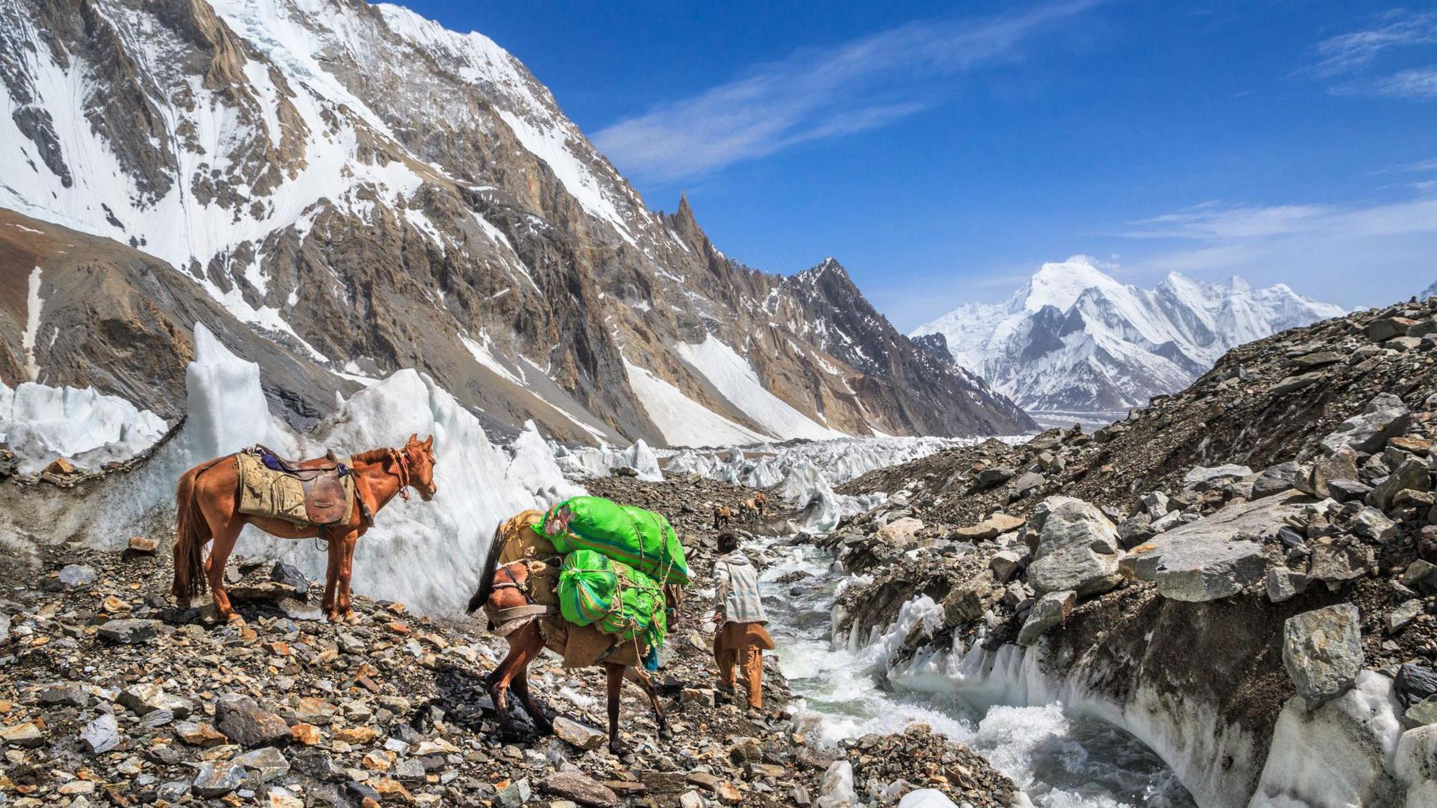 Horseman on Godwin-Austen glacier, returning from K2 base camp to Concordia, northern Pakistan