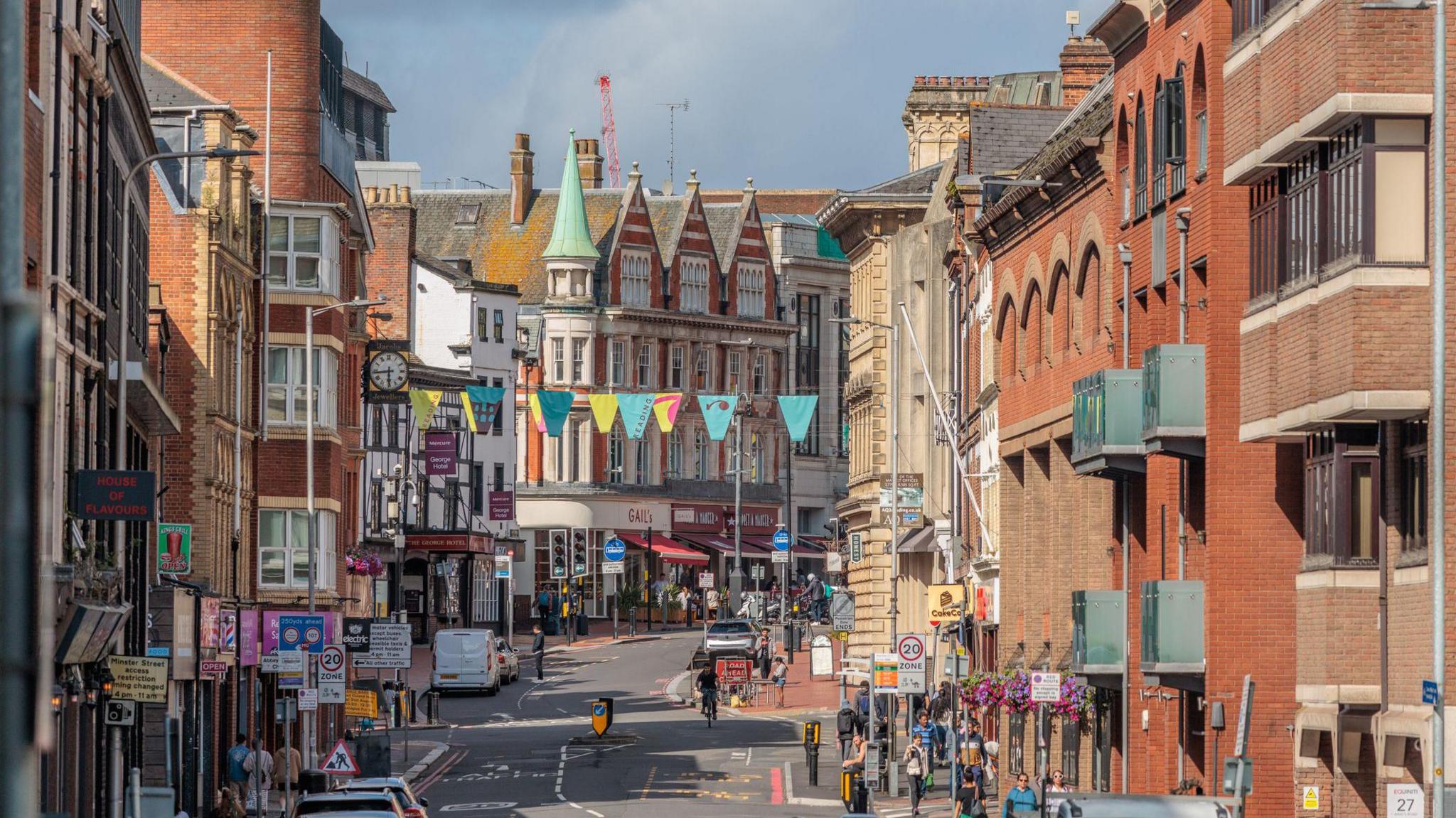 A picture of Reading town centre, with shops on the left side and flats and offices on the right side.