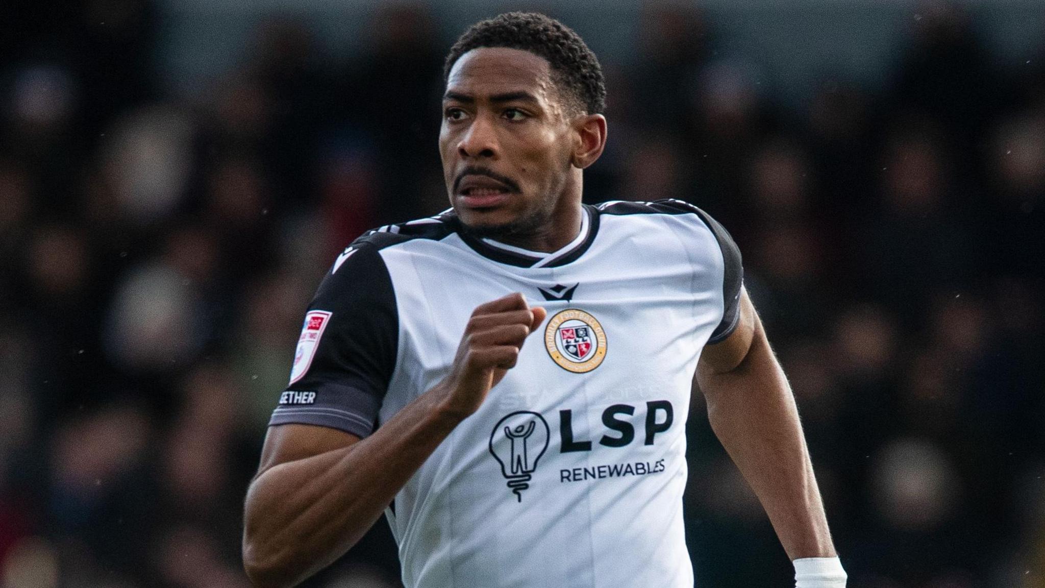 Zech Medley, wearing Bromley's white home shirt with black sleeves and black trim on the neck, in action during a game against Accrington Stanley in February 2026
