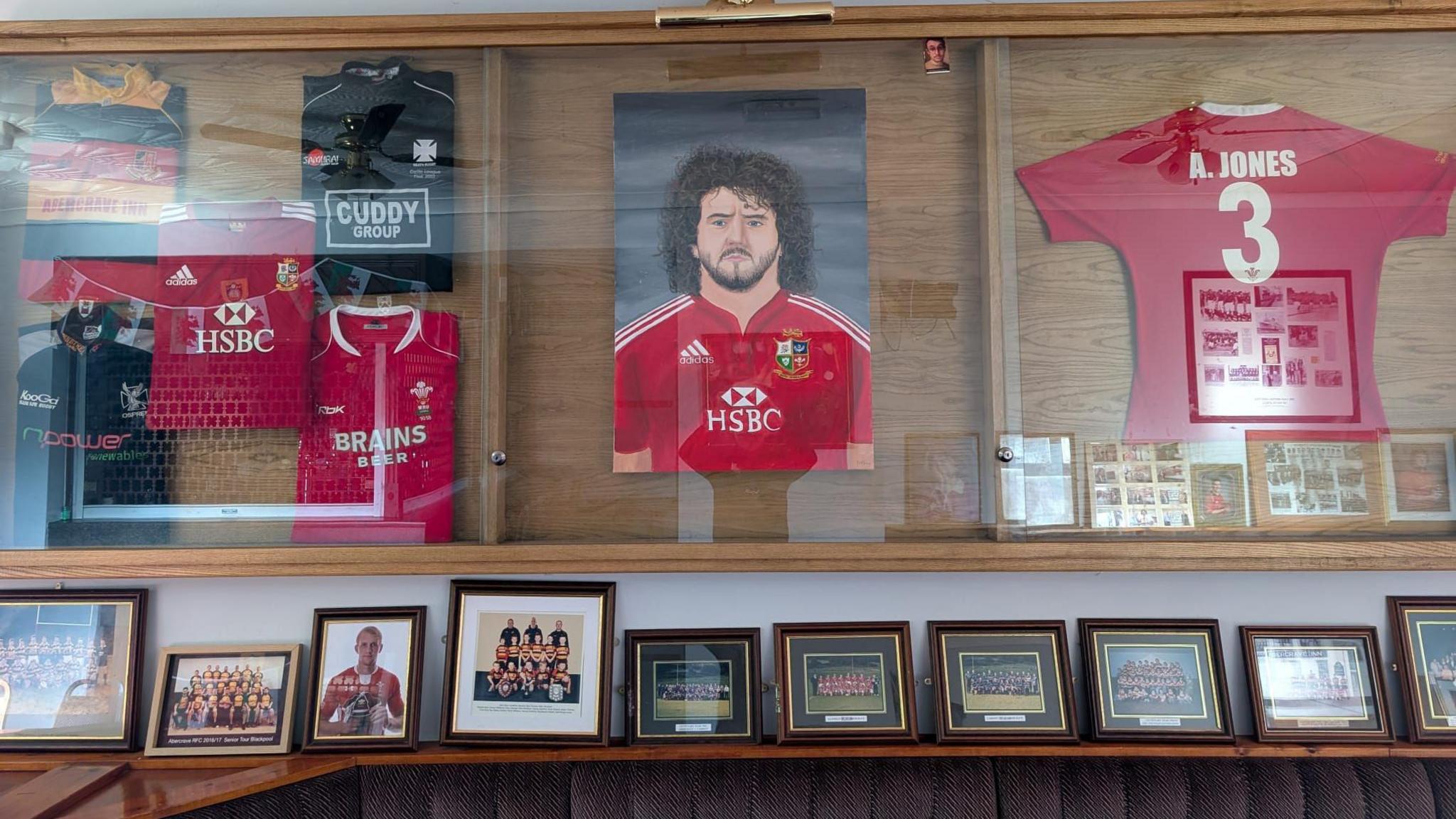 Memorabilia i ddathlu cyfraniad Adam Jones i rygbi Abercraf a Chymru yng nghabinet bar y clwb