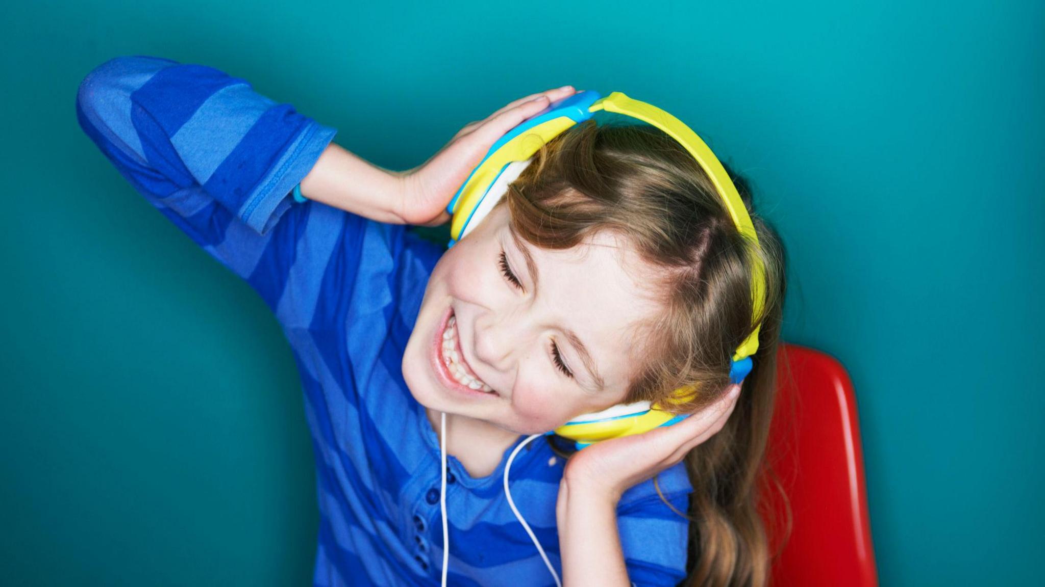 happy girl listening to music through headphones. 