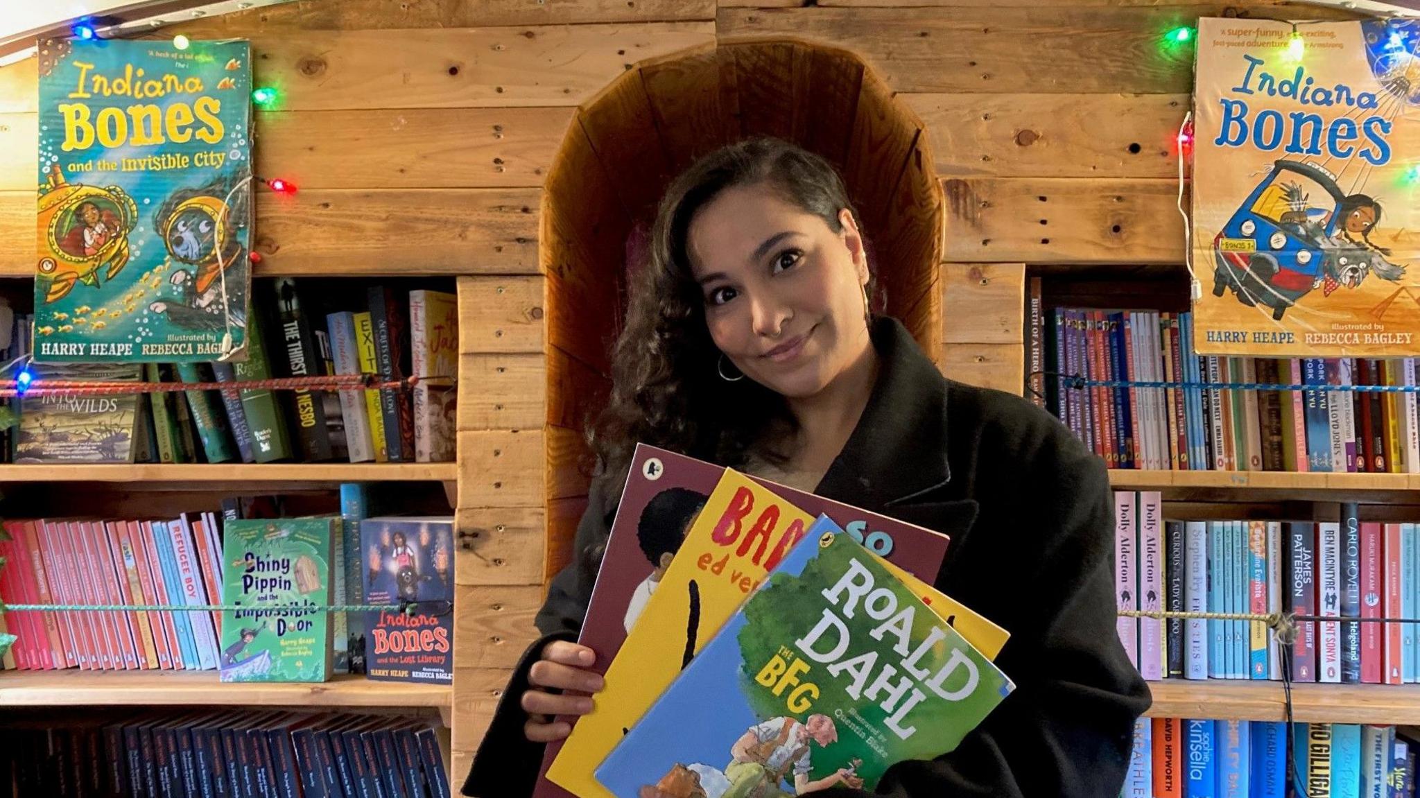 Bus book teacher holding some books 