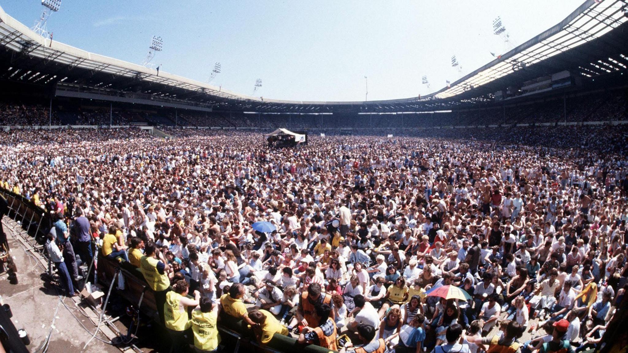 Thousands of people are seen in a picture taken from the stage at Live Aid in 1985, held at Wembley Stadium