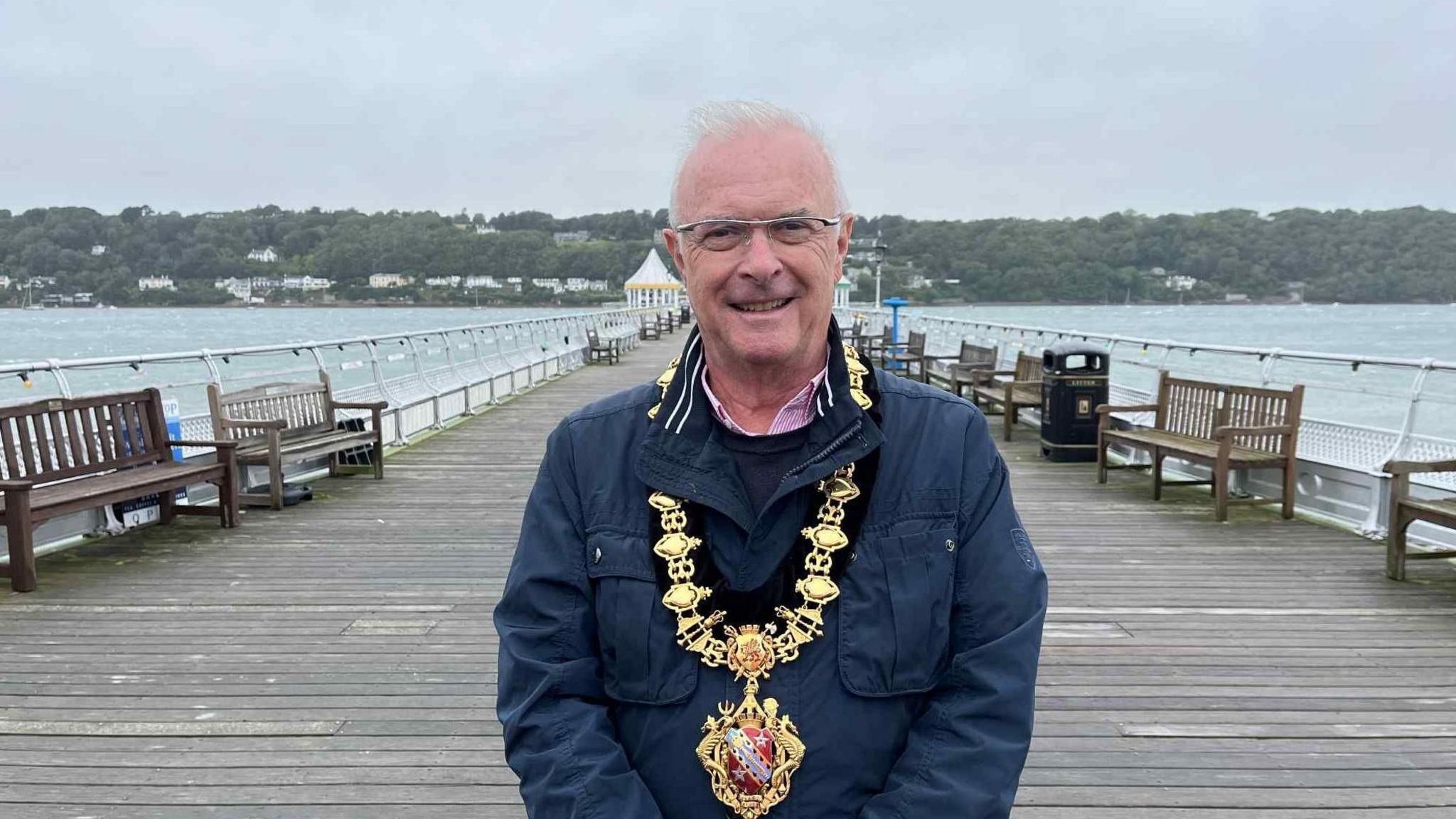 Cllr Medwyn Hughes standing on Garth Pier