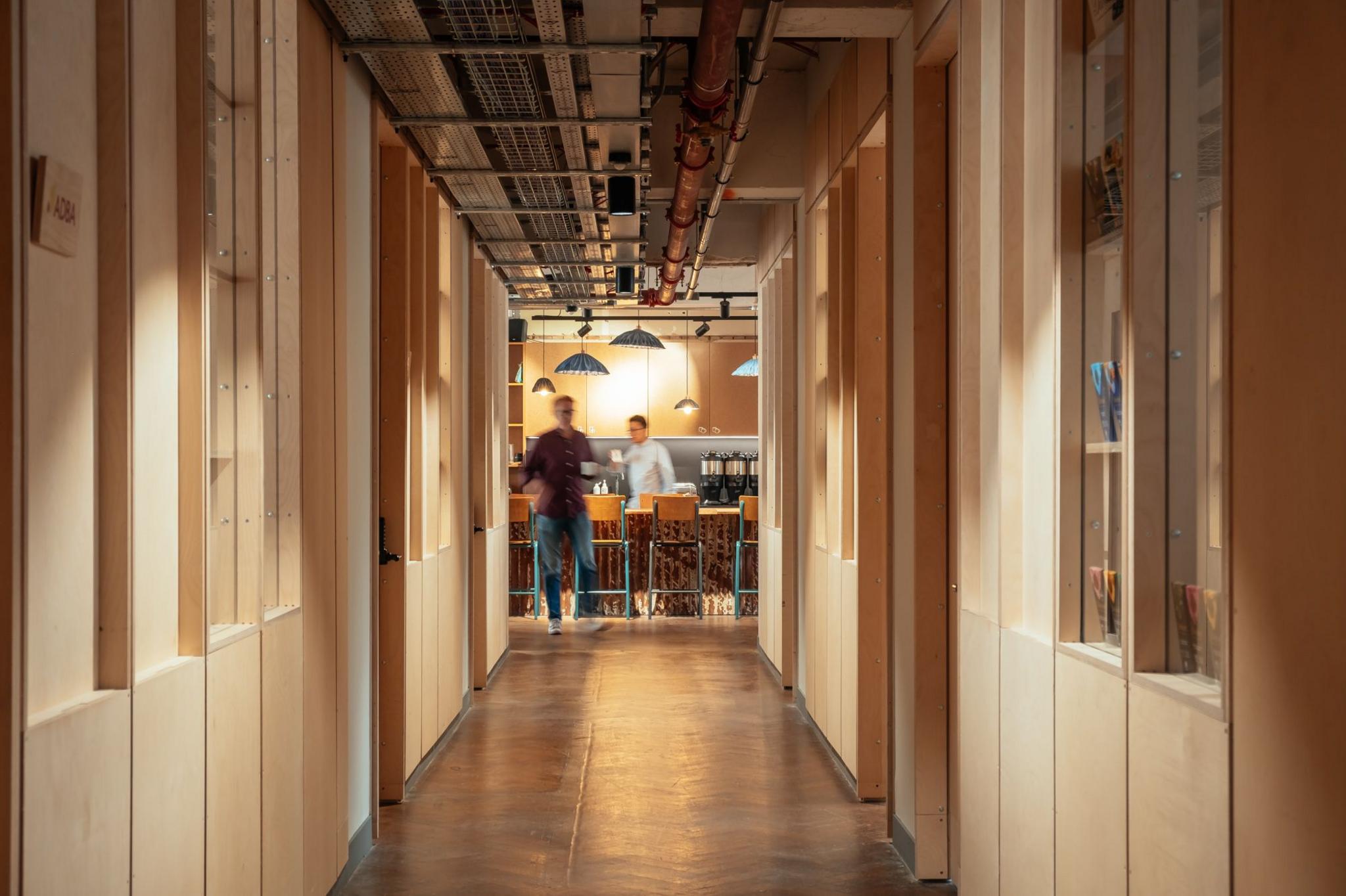 A corridor with wooden dividers marking out offices