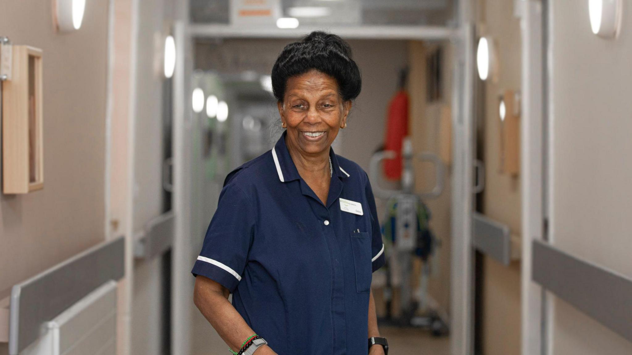 Nurse Daisy Richards pictured in a corridor at the care home where she works.