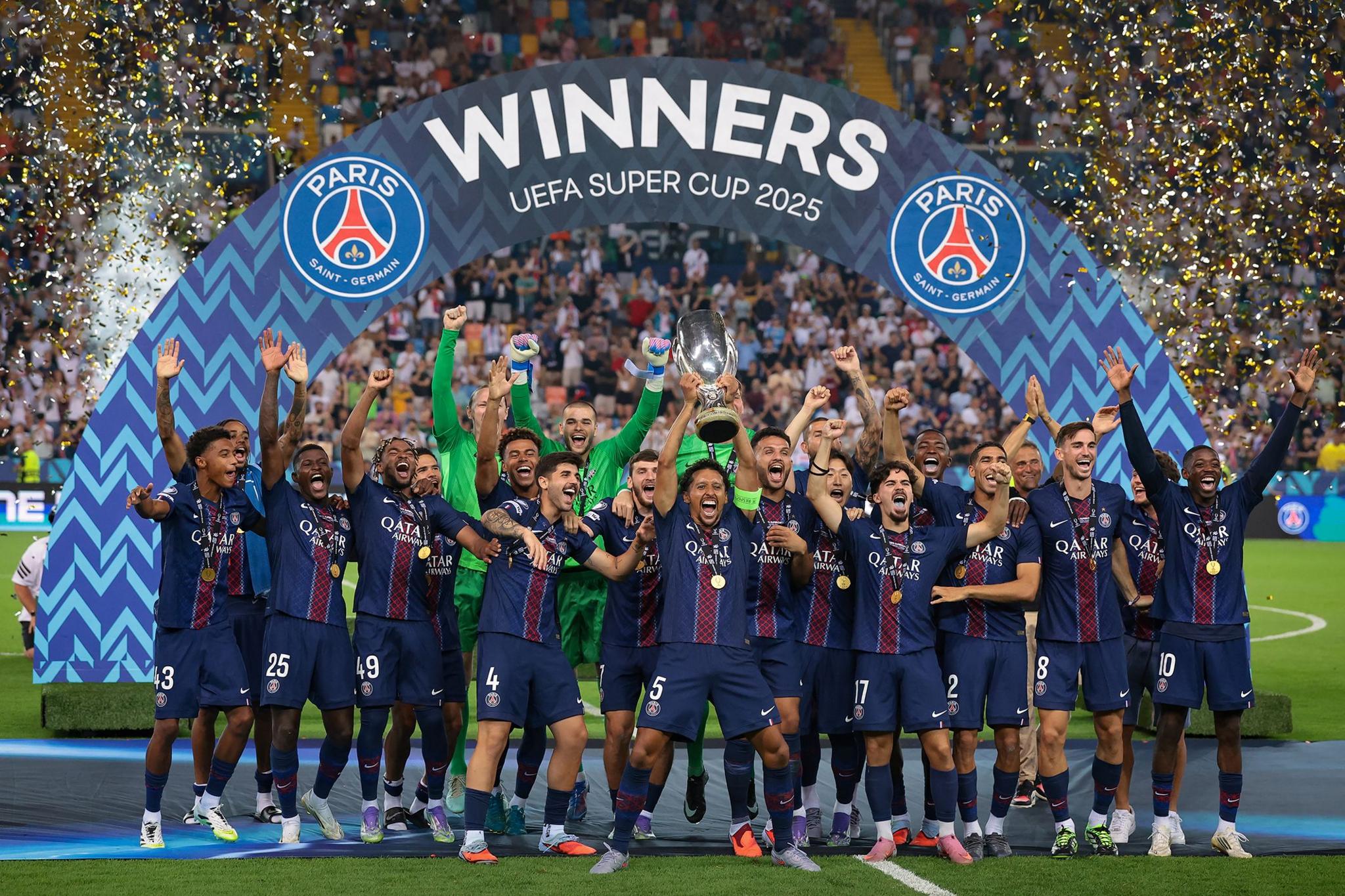 PSG's Marquinhos lifts the UEFA Super Cup trophy as he celebrates with teammates following the penalty shoot out victory at Friuli Stadium in Udine, Italy. Photo by Jonathan Moscrop