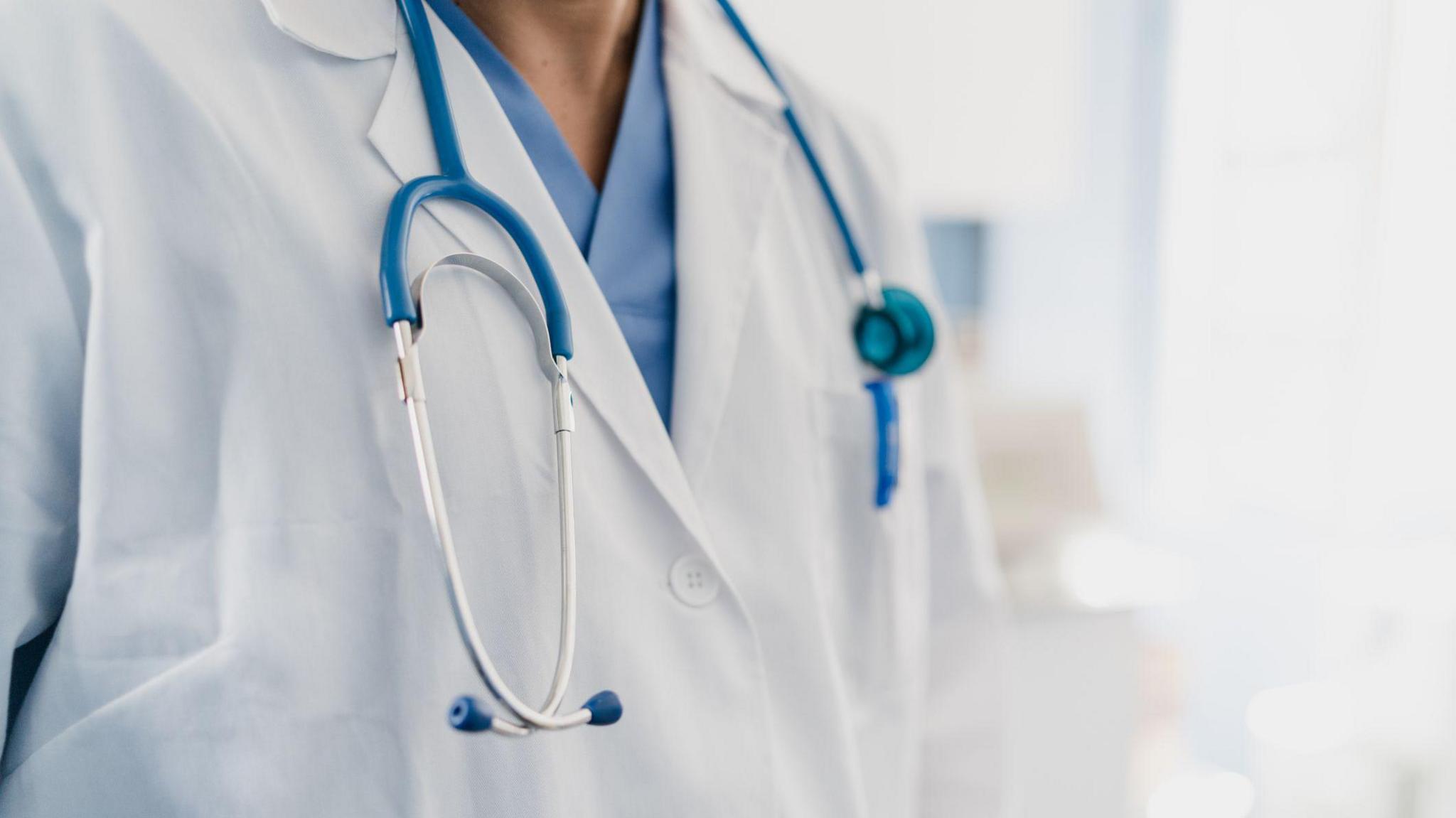 A doctor wearing a white lab coat with a stethoscope. 