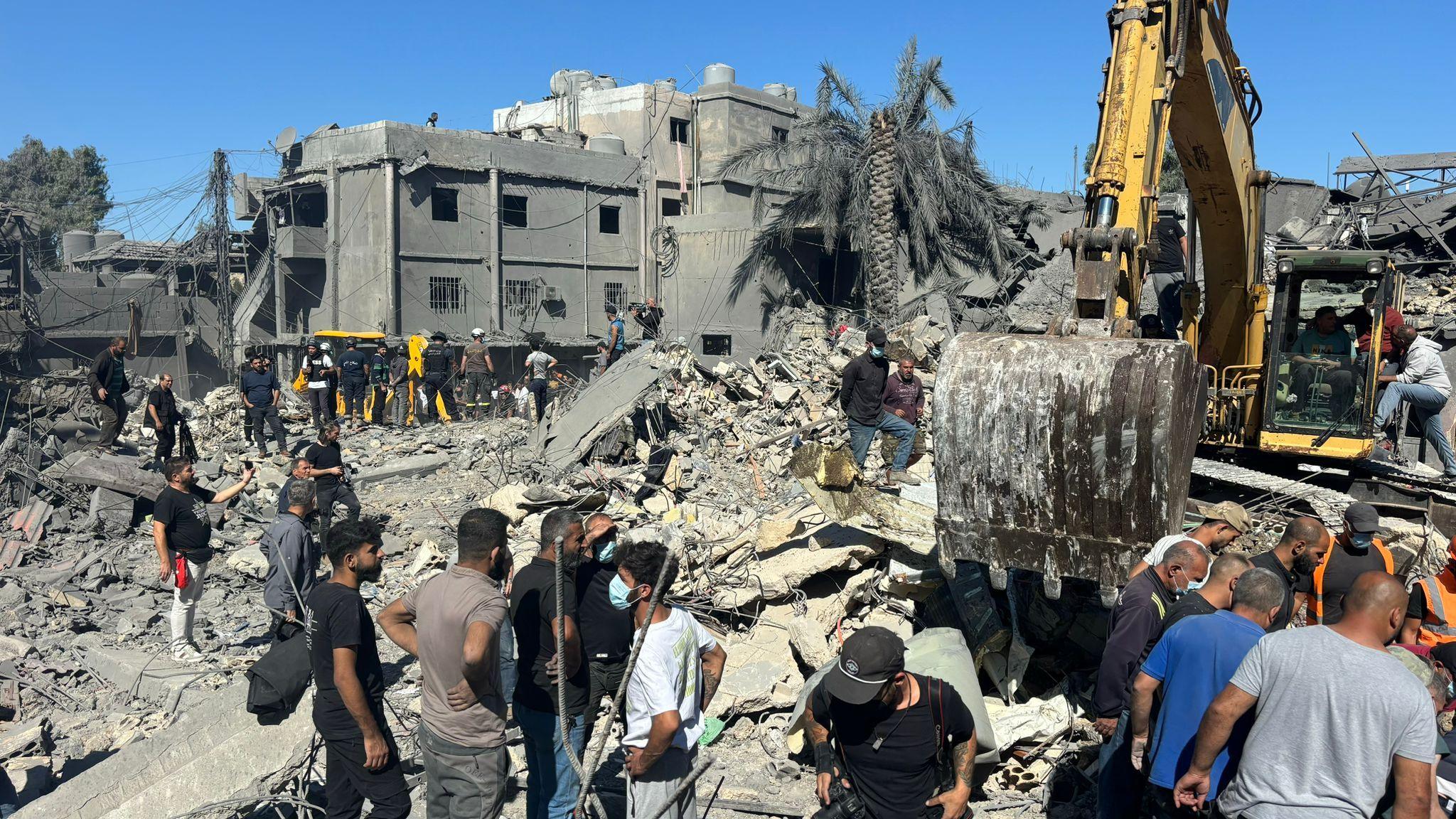 Rescue workers and civilians search for survivors after an Israeli air strike destroyed several buildings near Rafik Hariri University Hospital in southern Beirut, Lebanon (22 October 2024)