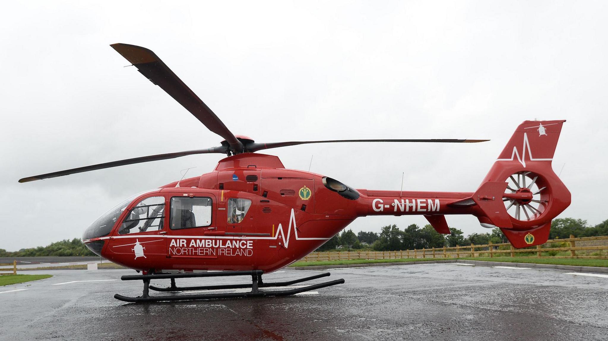 A red air ambulance is seen on a landing pad. 