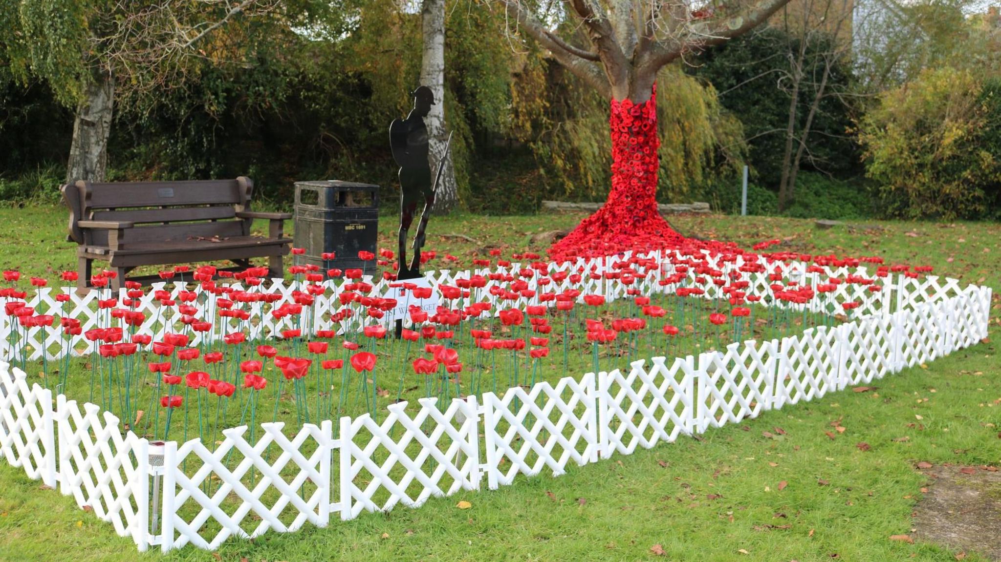 A tree covered with crochet poppies