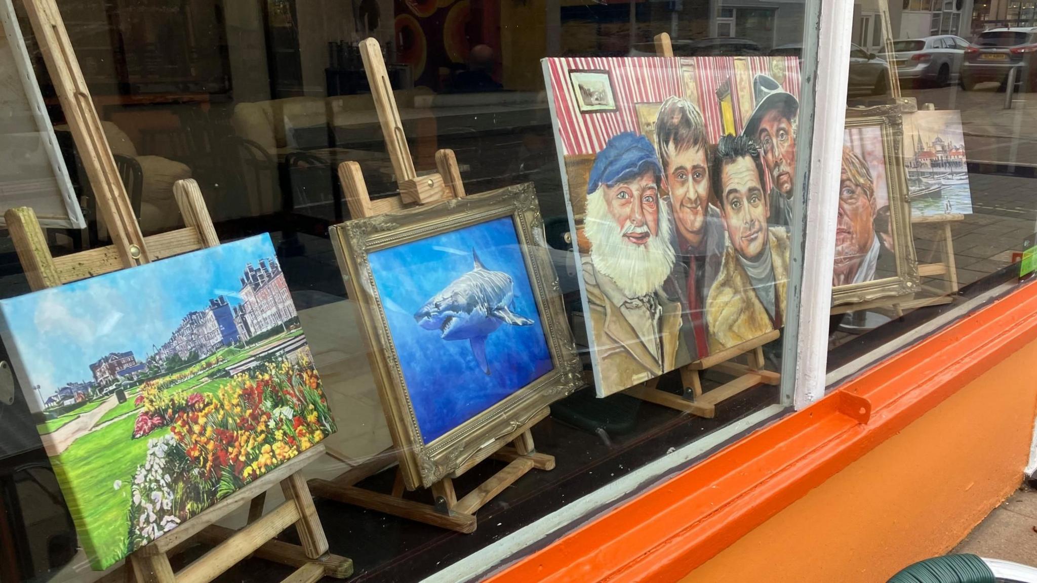 Artworks in the window of Desmonds, Lowestoft