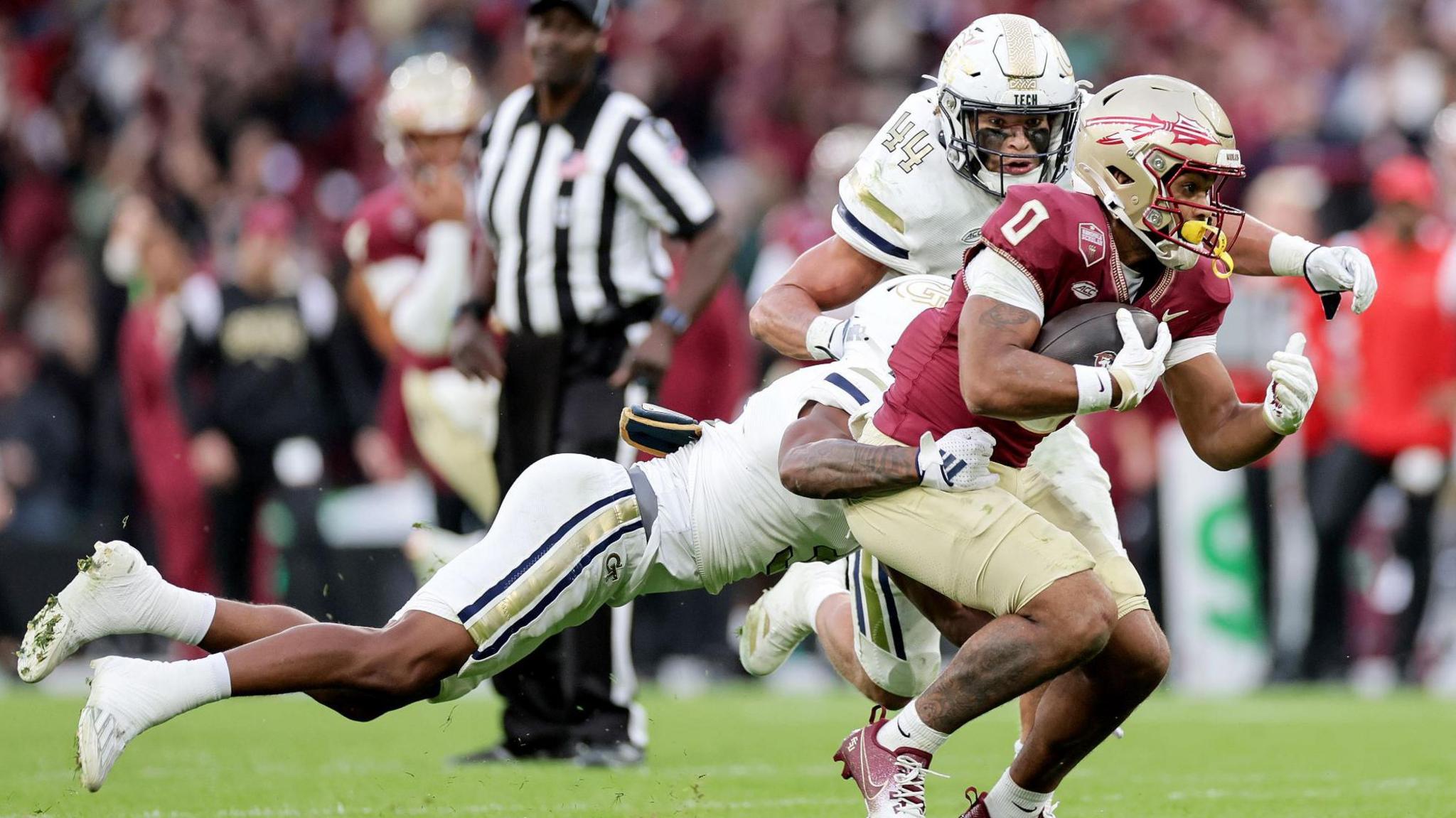 Florida State University's Ja’Khi Douglas is tackled by Ahmari Harvey and Kyle Efford of Georgia Tech at the Aviva Stadium in August