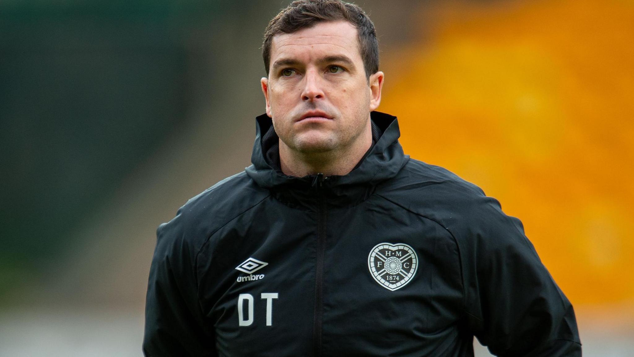 Dale Tonge wearing a Hearts jacket with his initials on