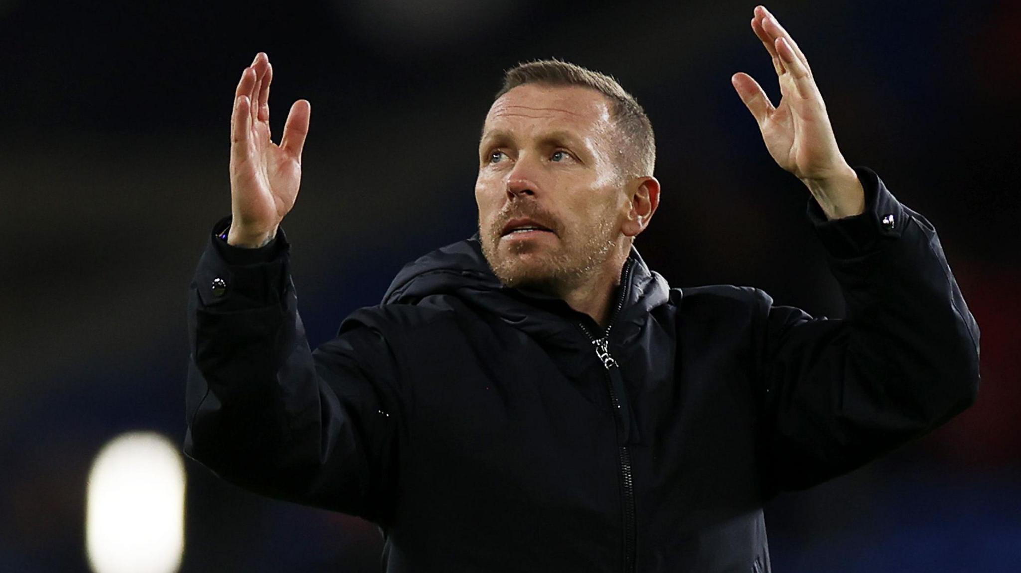 Craig Bellamy raises his hands