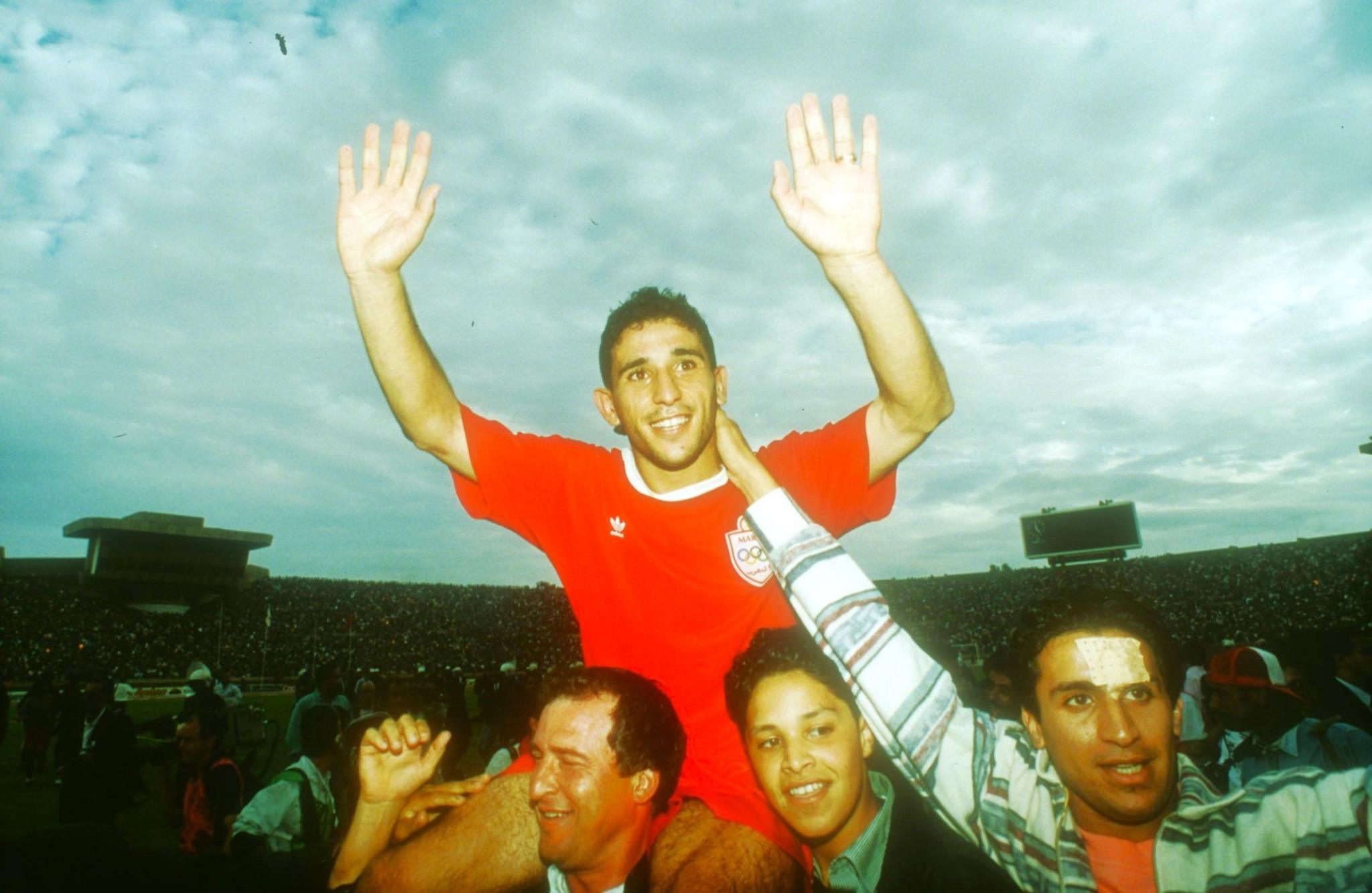 MOHAMMED CHADOUCH is carried off the pitch on the shoulders of spectators after his Morocco side beat Zambia in 1993