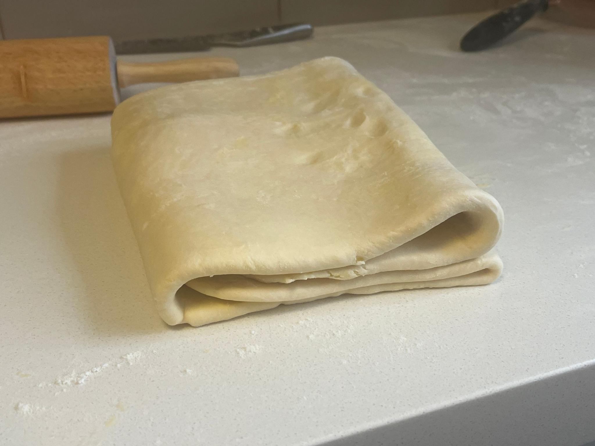 The dough has been rolled out and folded several times.
