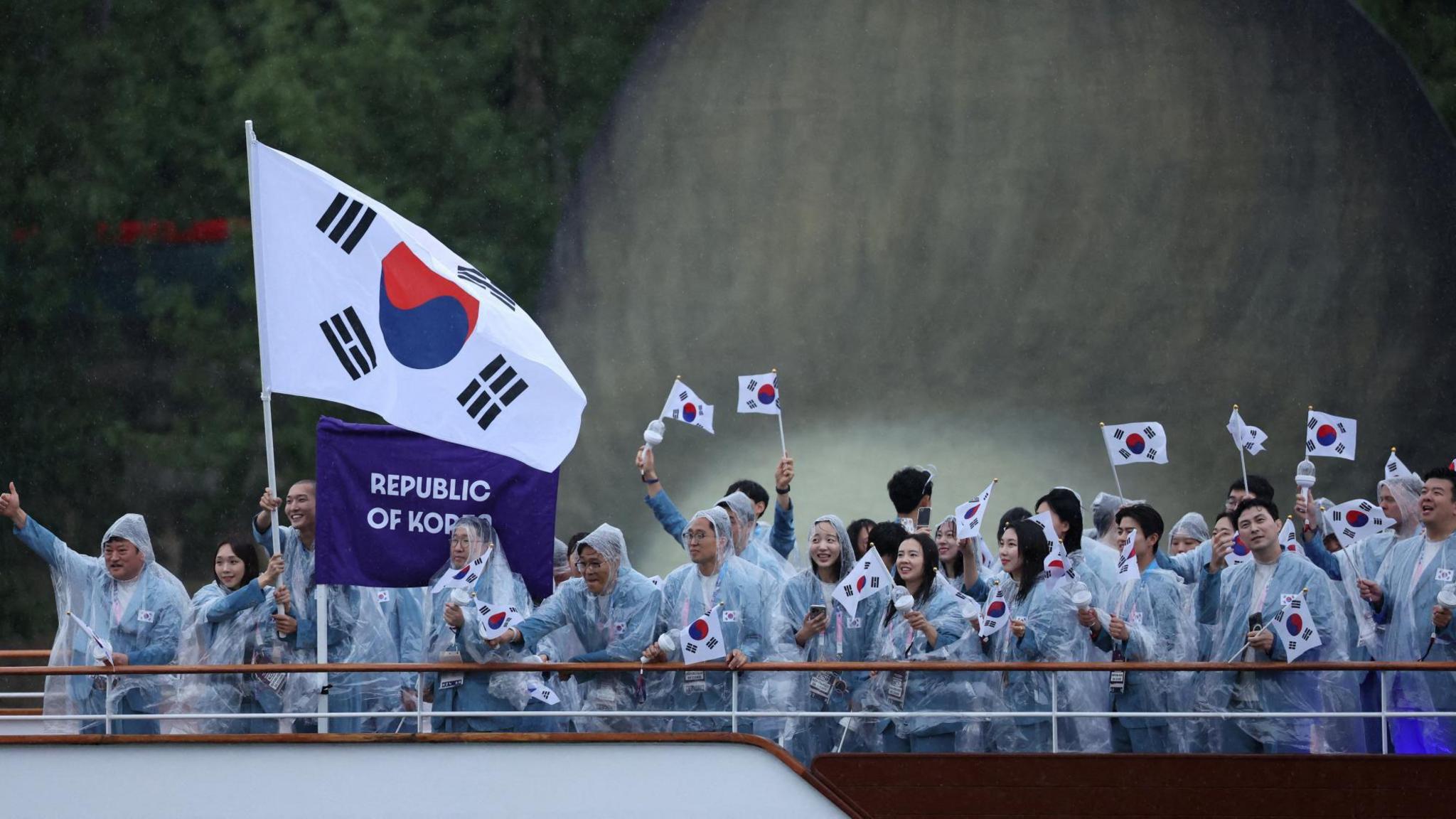 Paris 2024 Olympics - Opening Ceremony - Paris, France - July 26, 2024. Athletes of South Korea aboard a boat in the floating parade on the river Seine during the opening ceremony