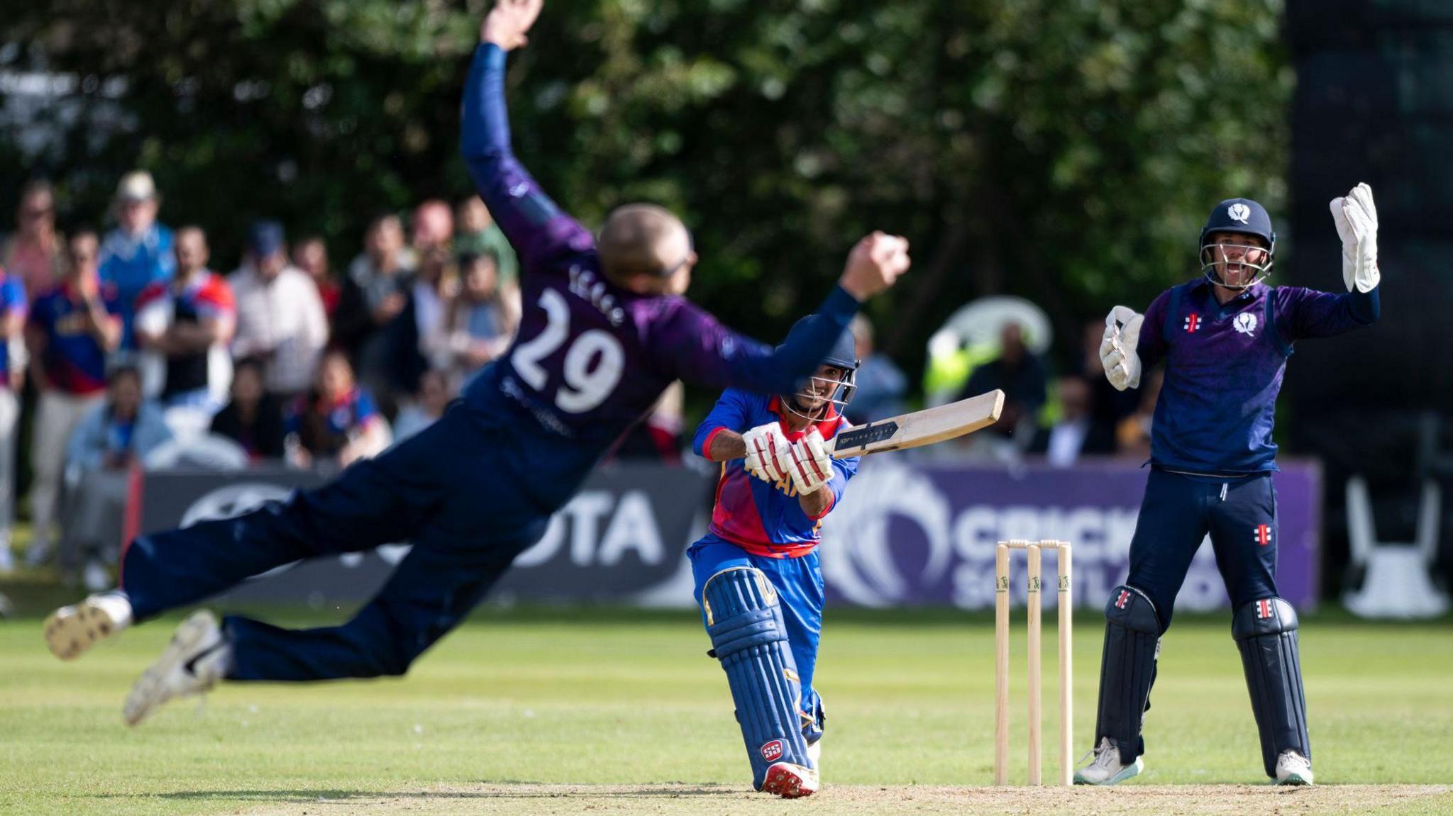Scotland's Michael Leask takes a catch against Nepal