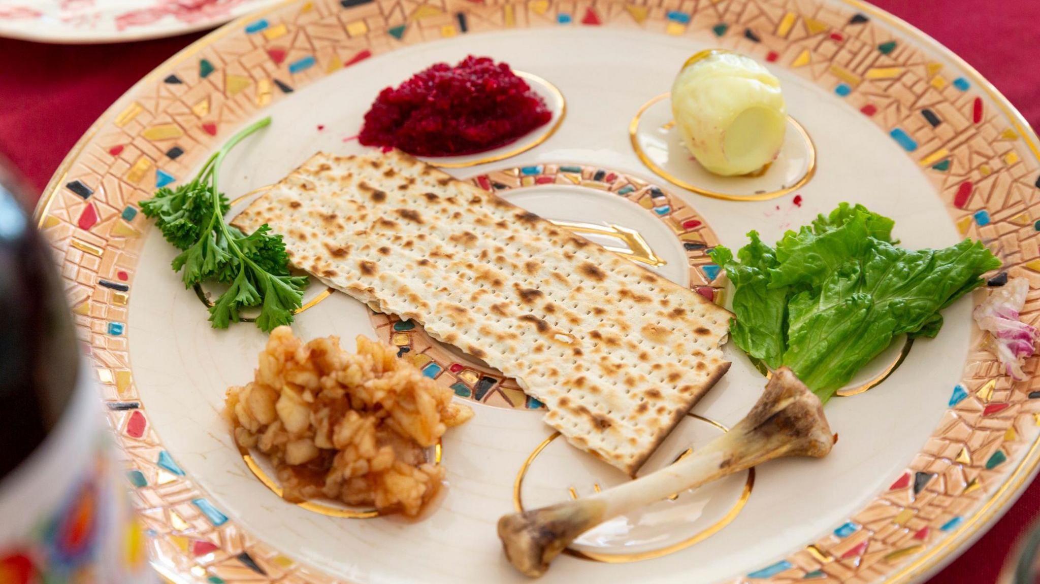A Passover Seder plate with Charoset, Maror or Bitter Herbs, Karpas, Zeroah or Lamb Shank, Beitza or Roasted Egg, and Matzoh