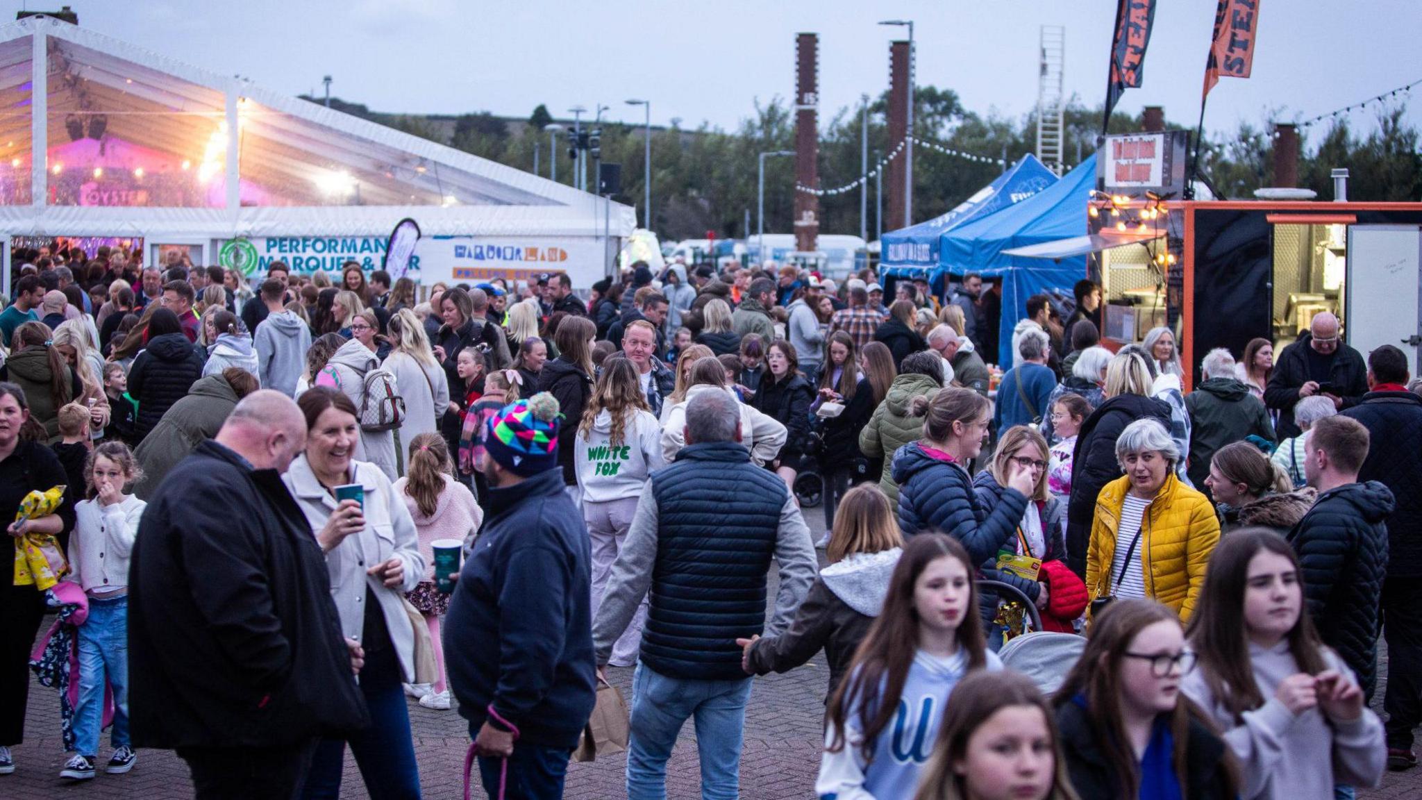 A large crowd milling around at the oyster festival