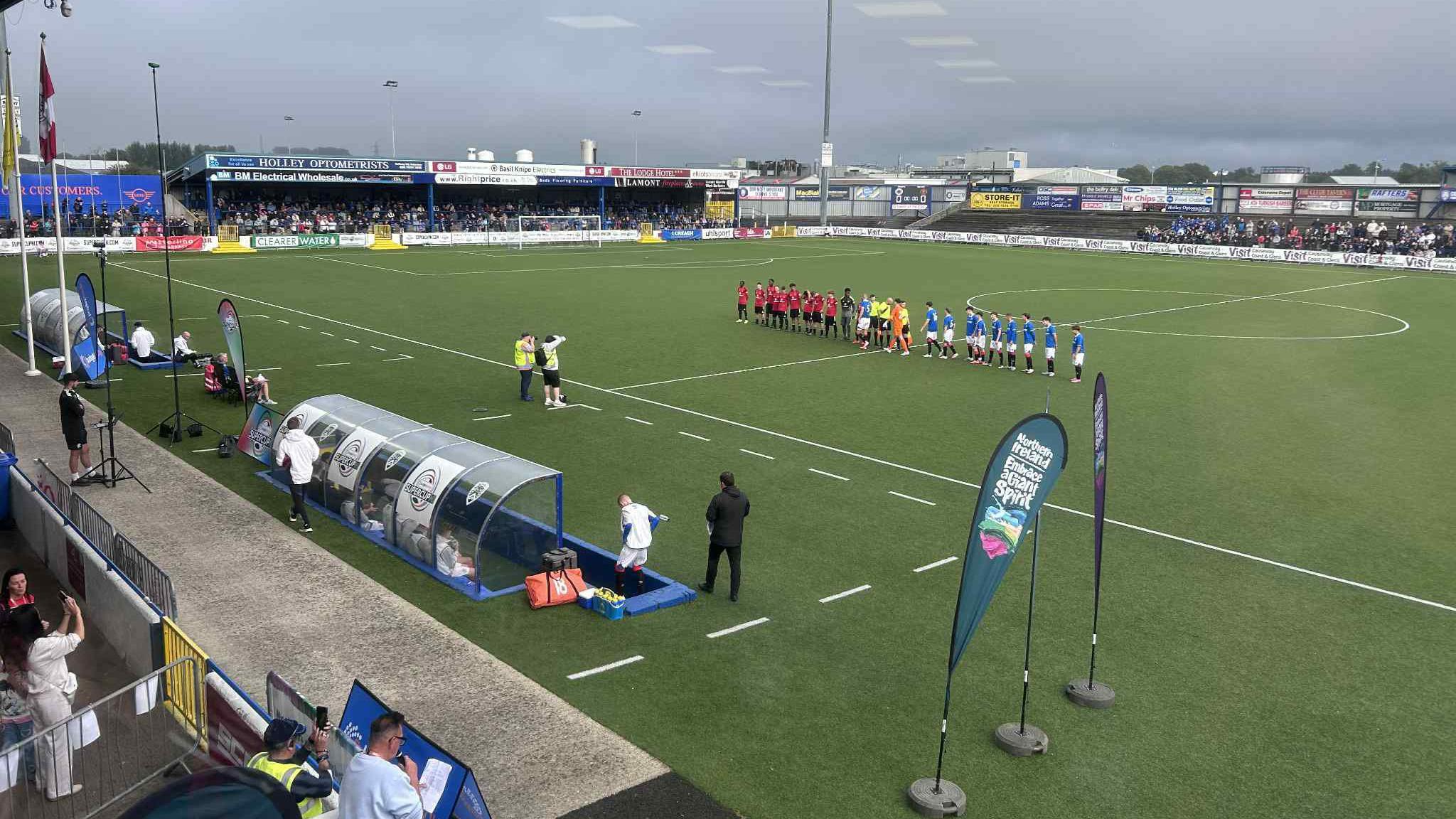 The junior teams of Rangers and Manchester United line up alongside each other on the pitch.