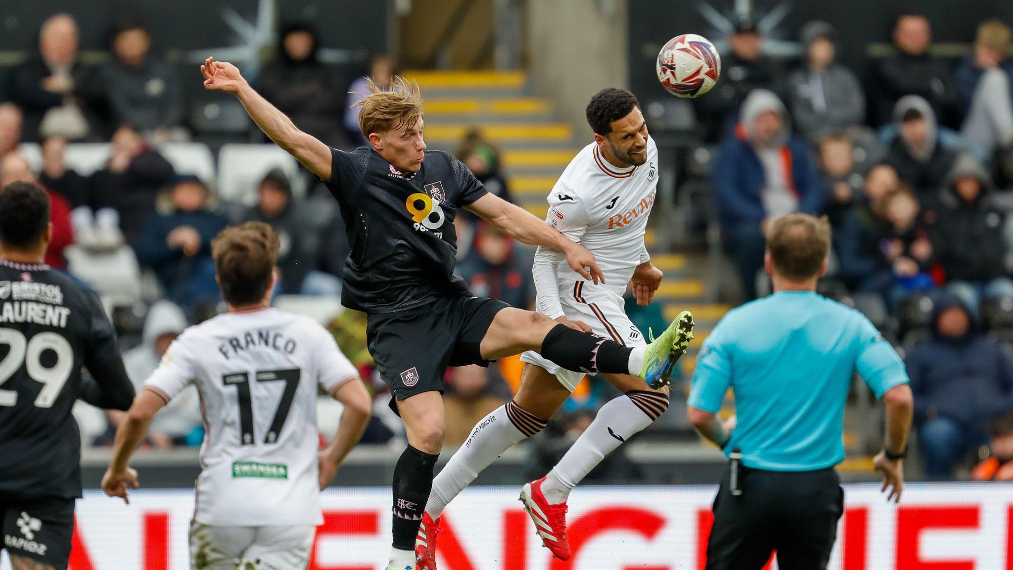 Ben Cabango and Zian Flemming compete for a header