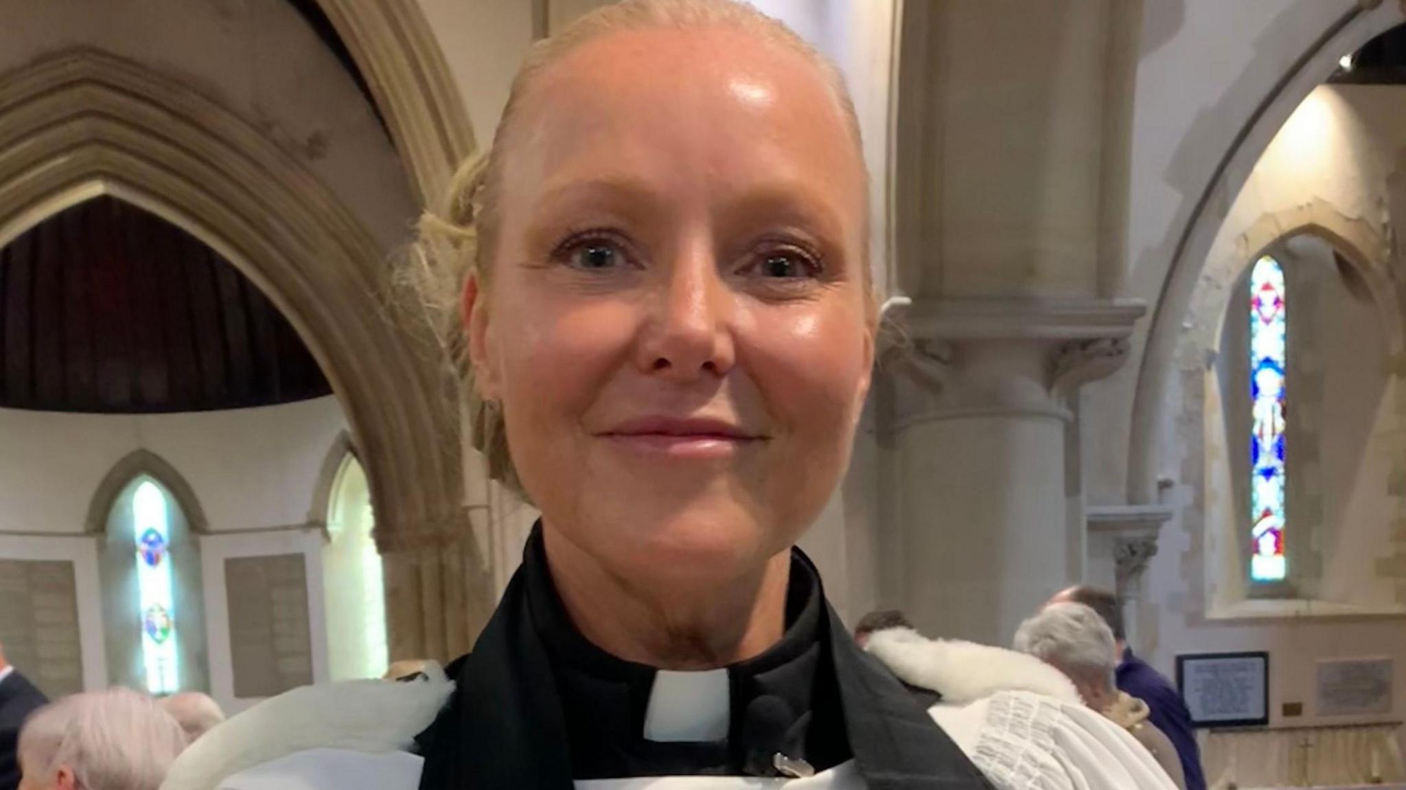 Samantha Martell stood in the church wearing her official clothing.
