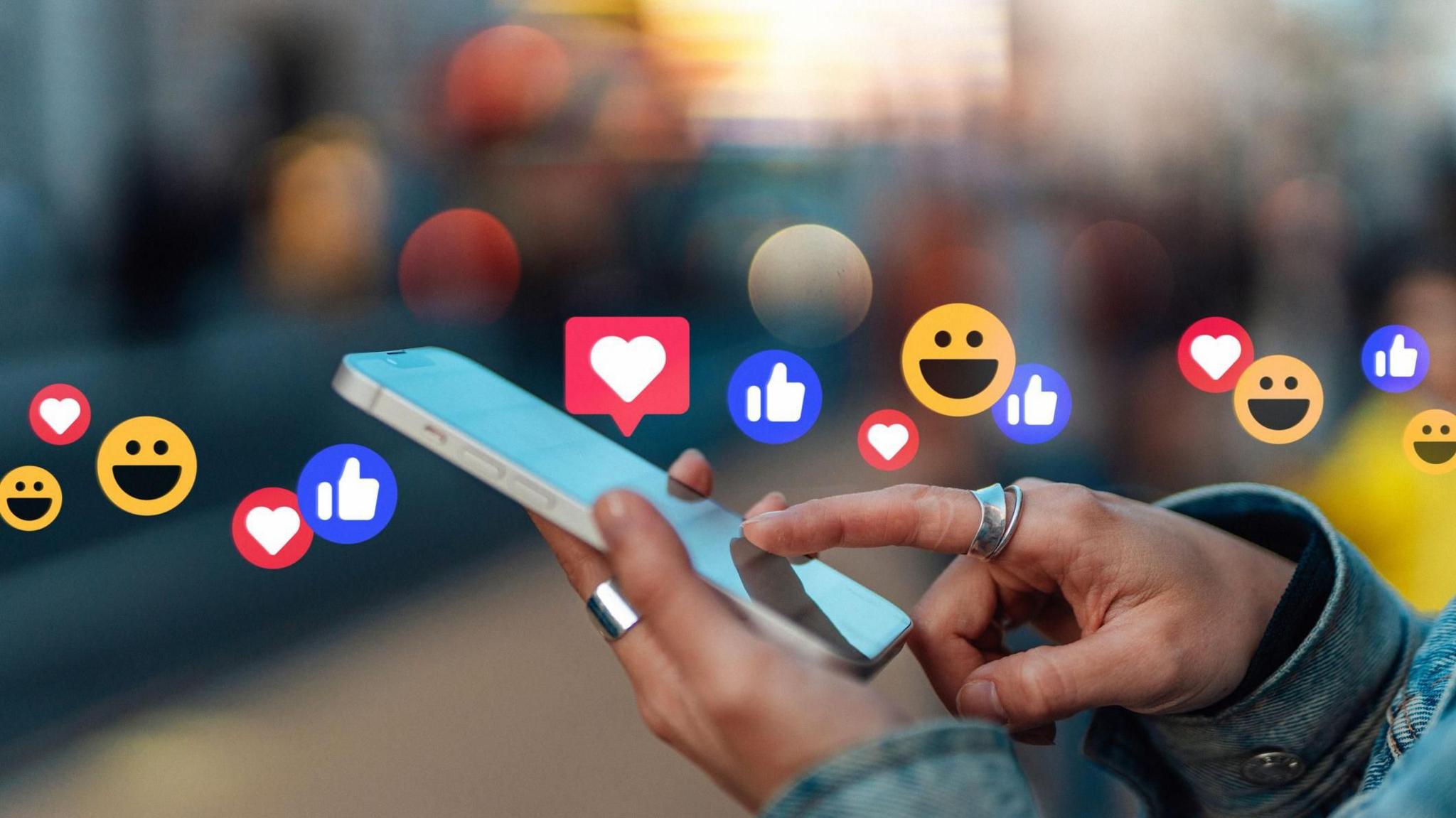 Close-up of female hand touching screen, giving likes and commenting on social media platform with smartphone. 