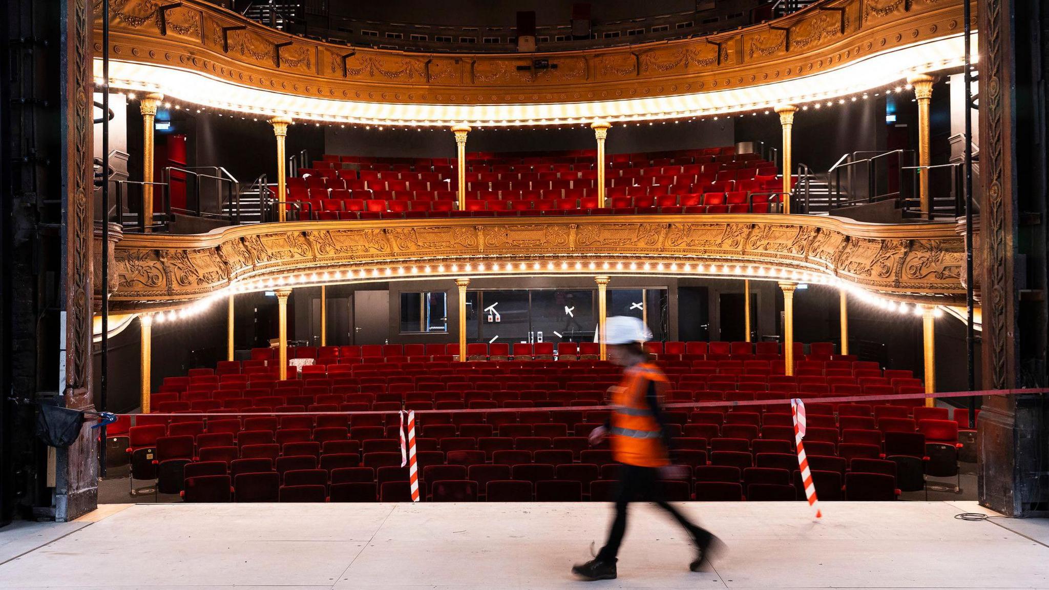 A photo of the auditorium with red plush seats and gold plasterwork