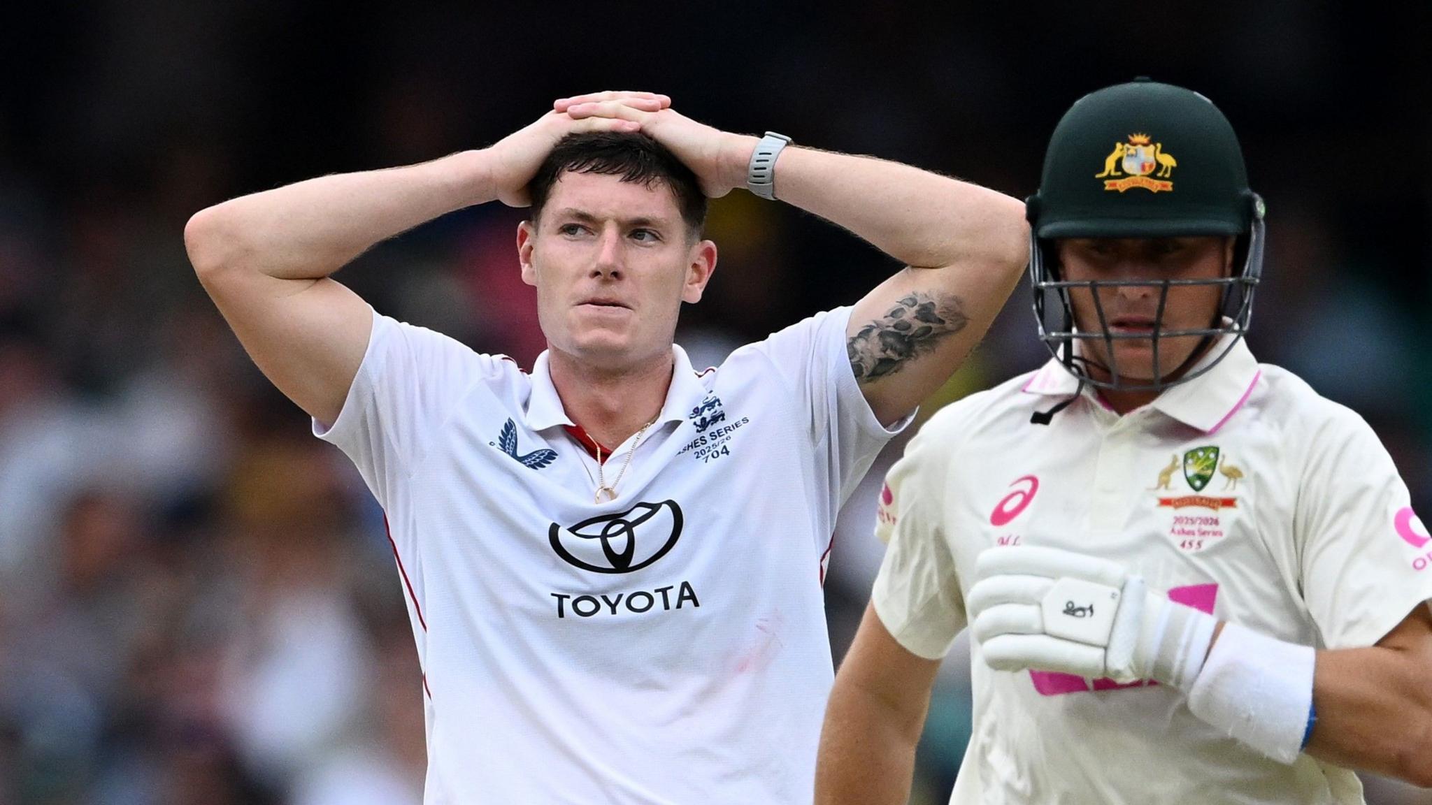 Matthew Potts stands with his hands on his head