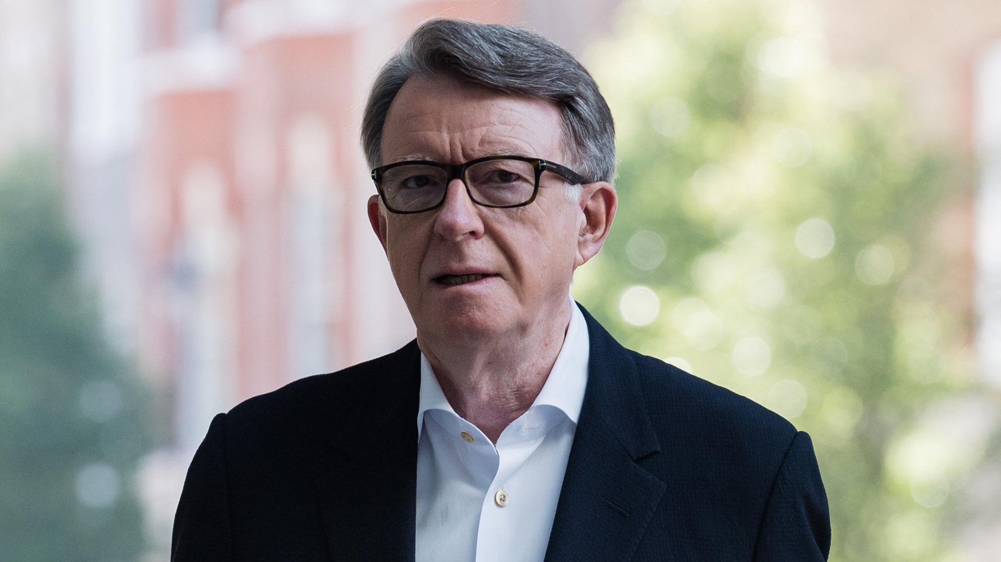 Lord Mandelson pictured outside wearing a blue shirt and dark blazer.