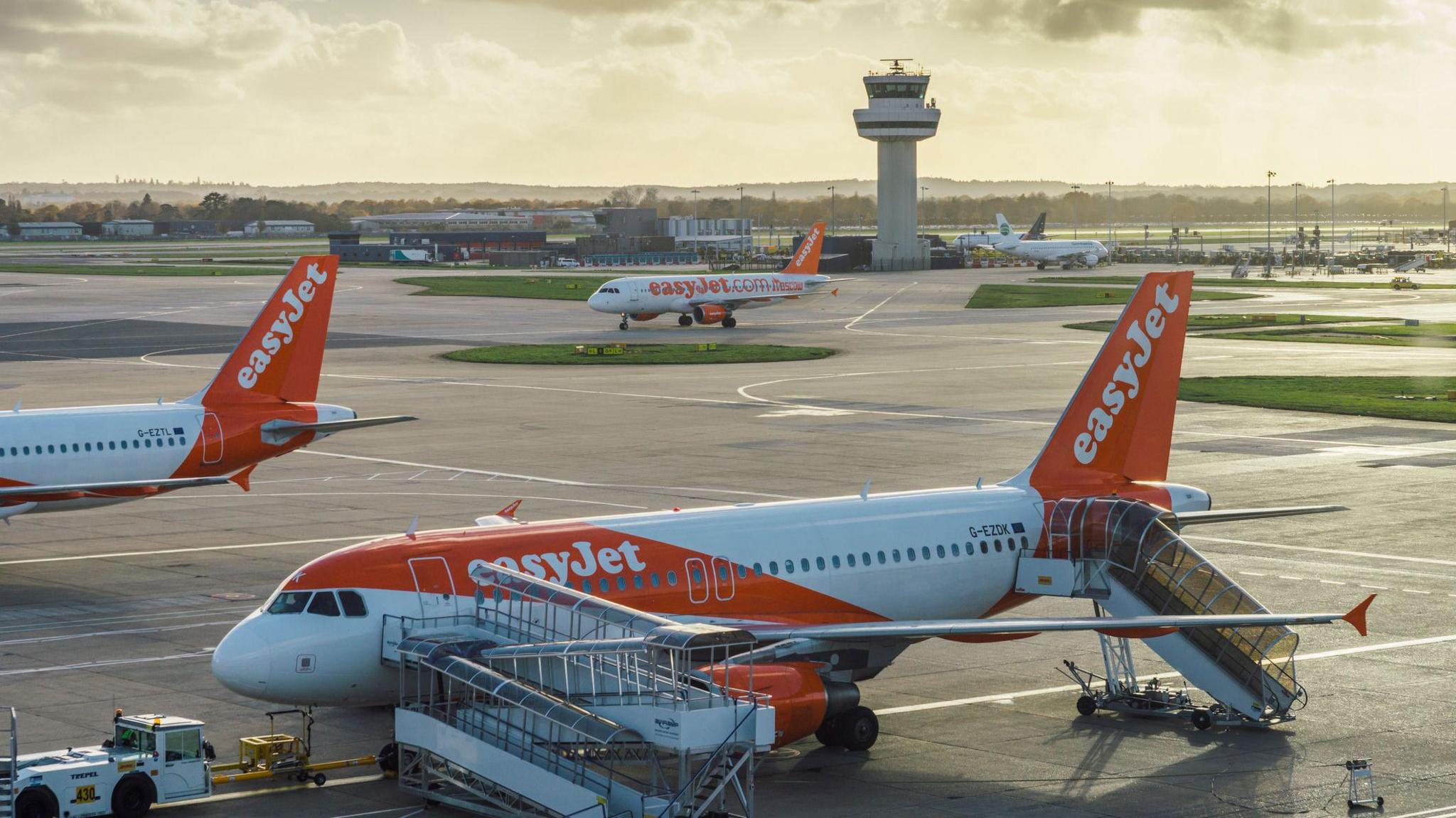 Easyjet airplanes at London's Gatwick airport - SouthTerminal - stock photo