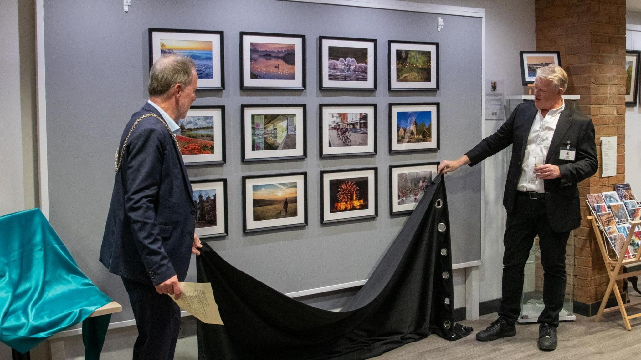 The Mayor of Guildford unveils the photographs at the launch event.