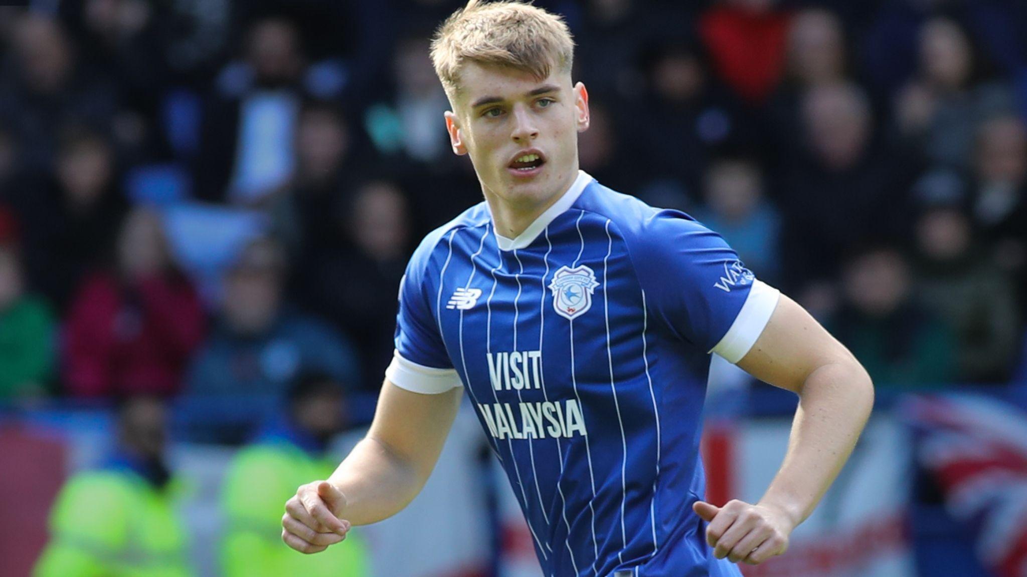Dylan Lawlor runs in the blue shirt of Cardiff City