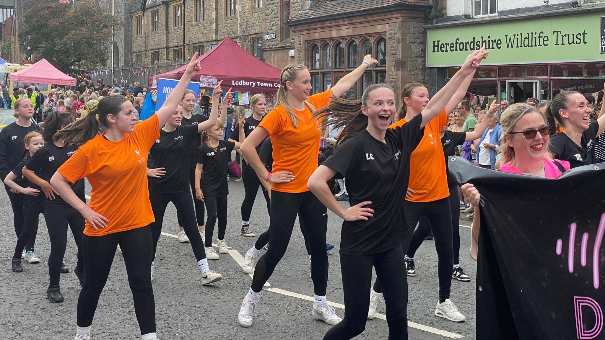 Women performing a dance routine in the carnival procession