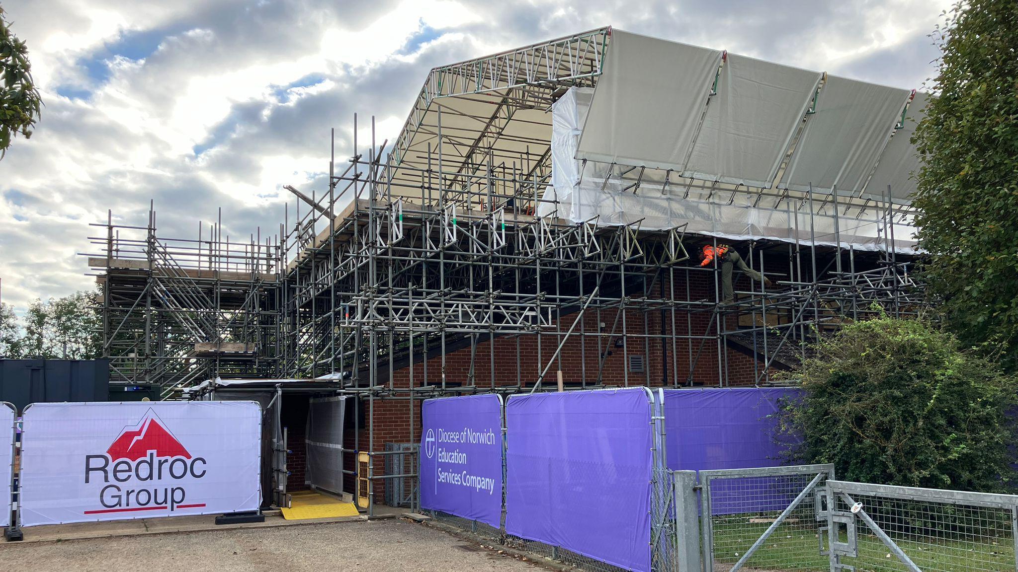 We can scaffolding and fencing surrounding the school hall.