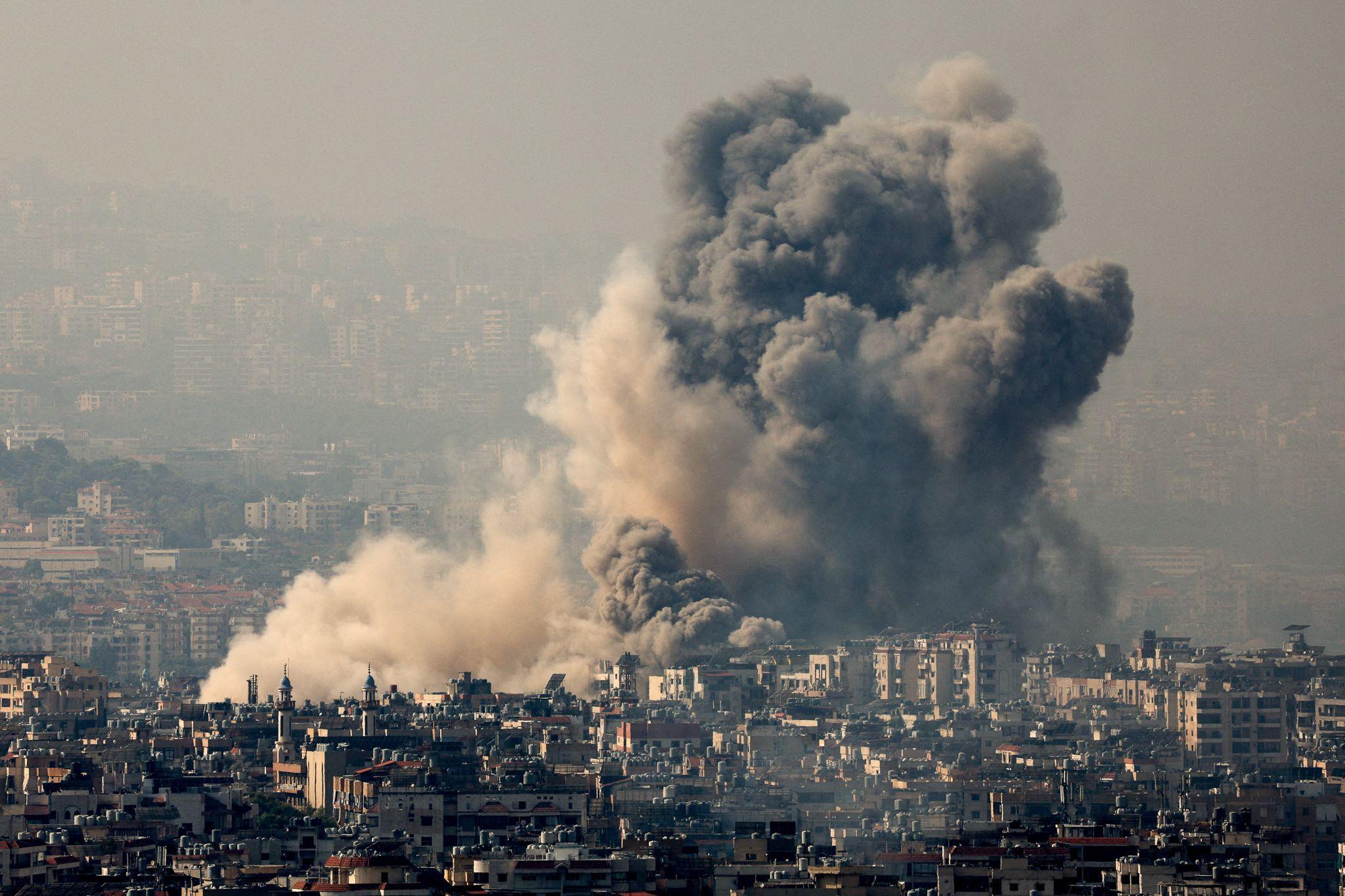 A cloud of smoke rises over Dahieh after a strike. Israel has bombed the suburb at least 54 times over the past few weeks.