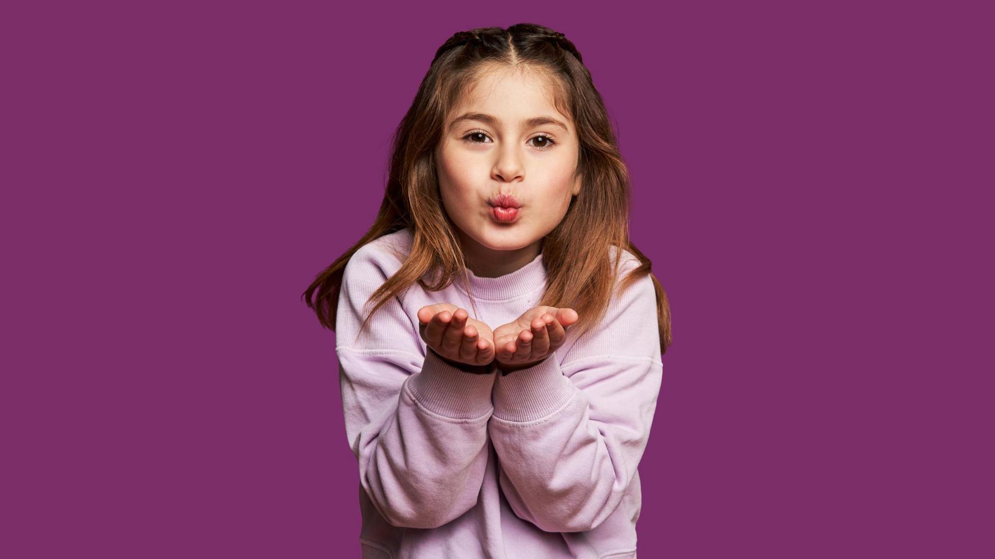 A girl blowing a kiss to the camera