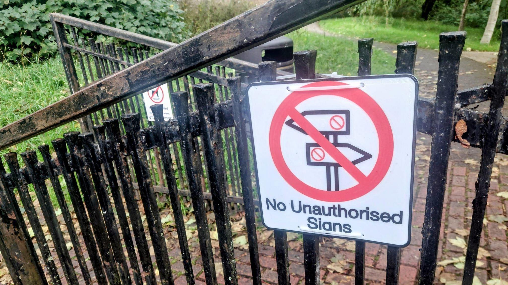 A joke sign reads: Unauthorised leaf shedding is prohibited. Trees failing to comply may face removal. 