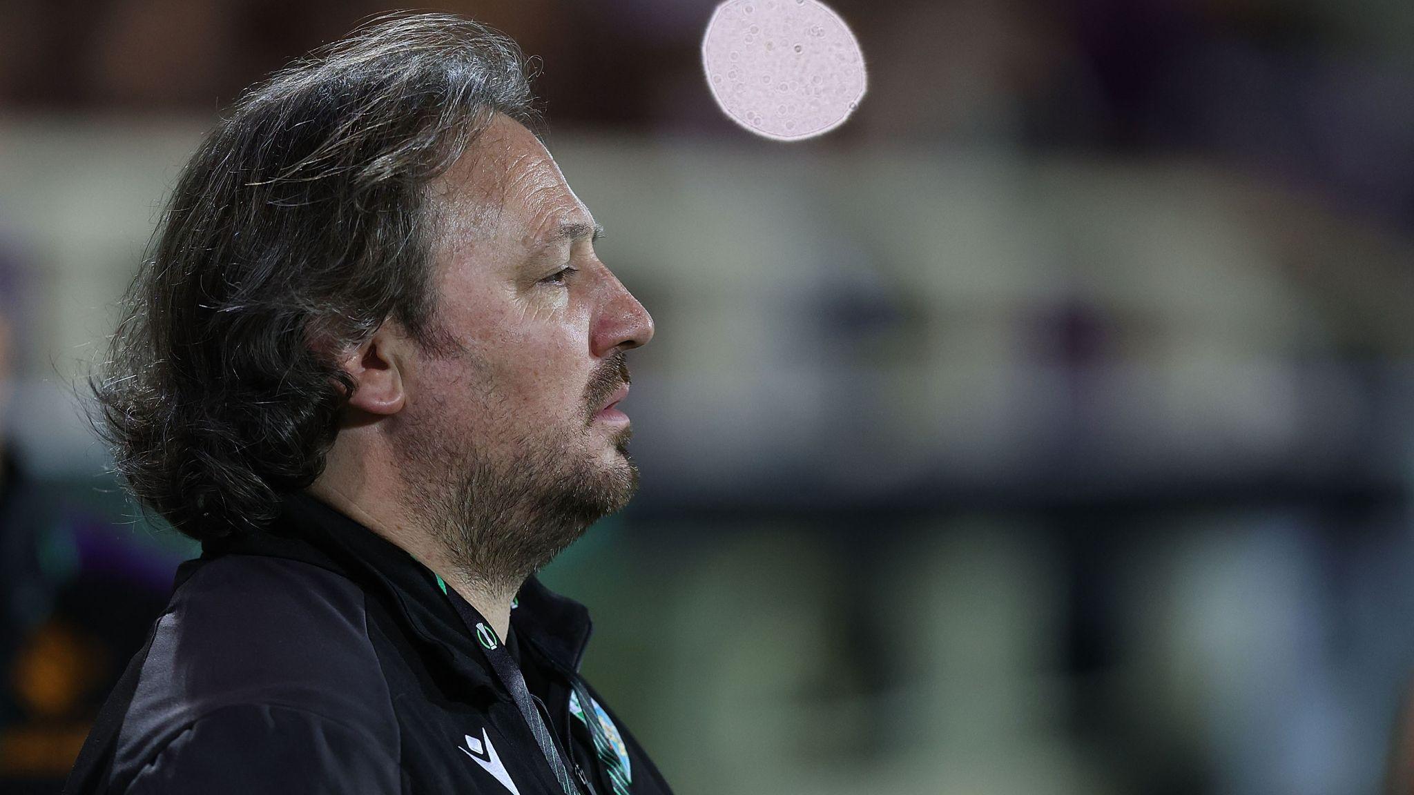 The New Saints manager Craig Harrison looks reflective on the touchline during his side's game at Fiorentina