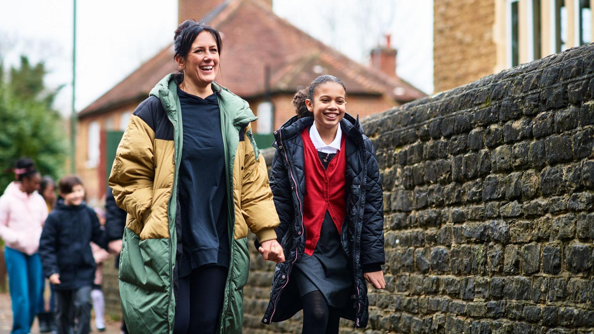 a mother and child walking to school