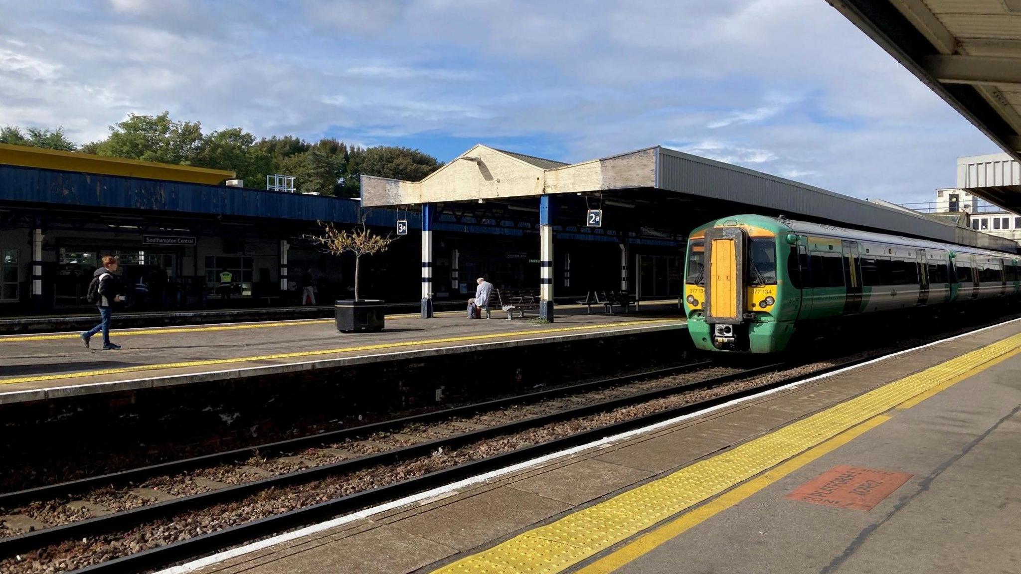 Green and yellow Southern train pulling into a platform at Southampton Central Station