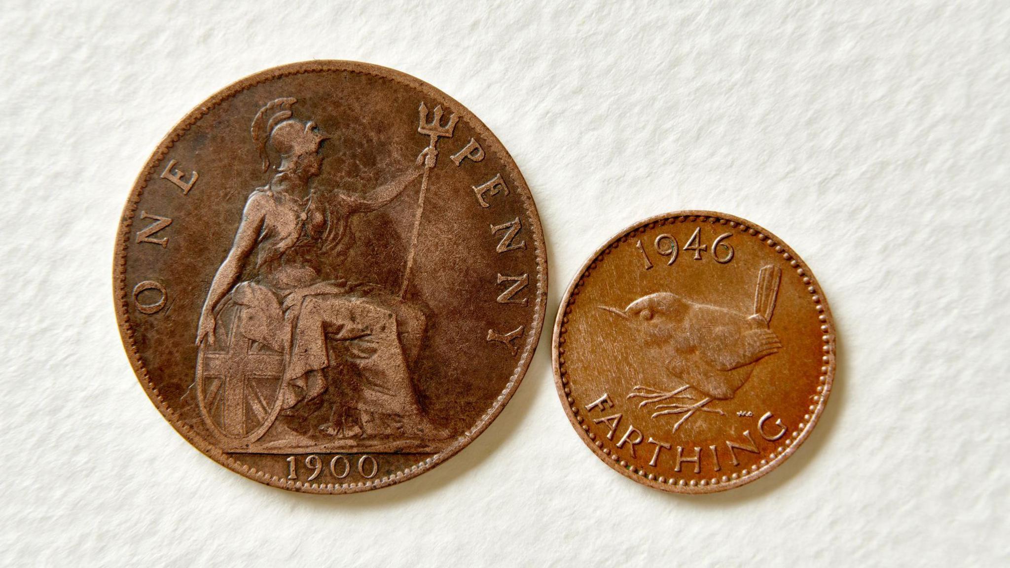 A 1900 penny coin on the left, with a 1946 farthing coin on the right