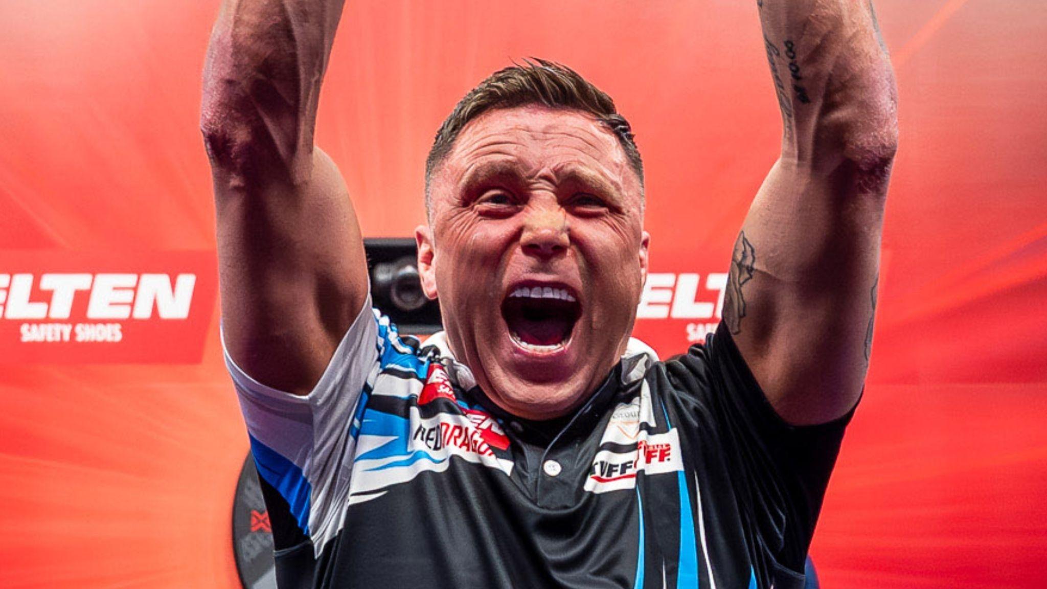 Gerwyn Price raises his arms aloft and shouts in celebration