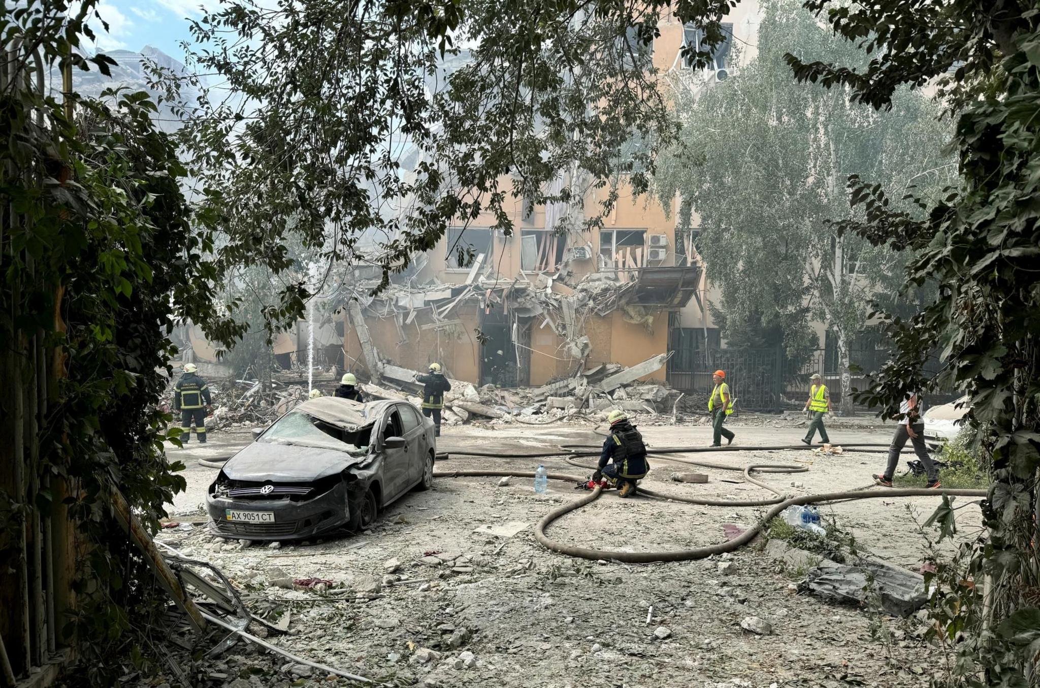 Rescuers work at the site of a Russian missile strike