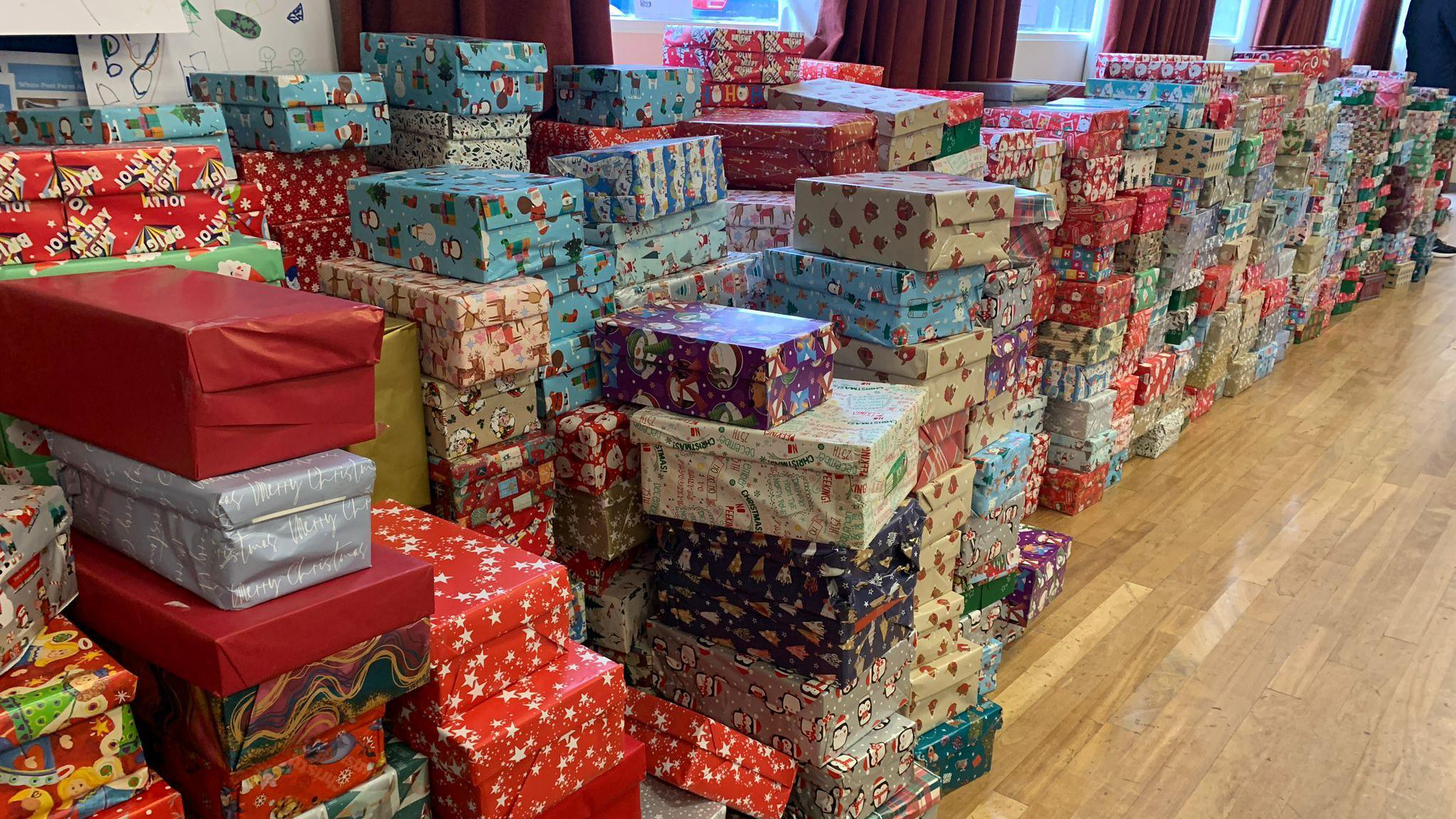 Packed shoeboxes in Christmas wrapping paper