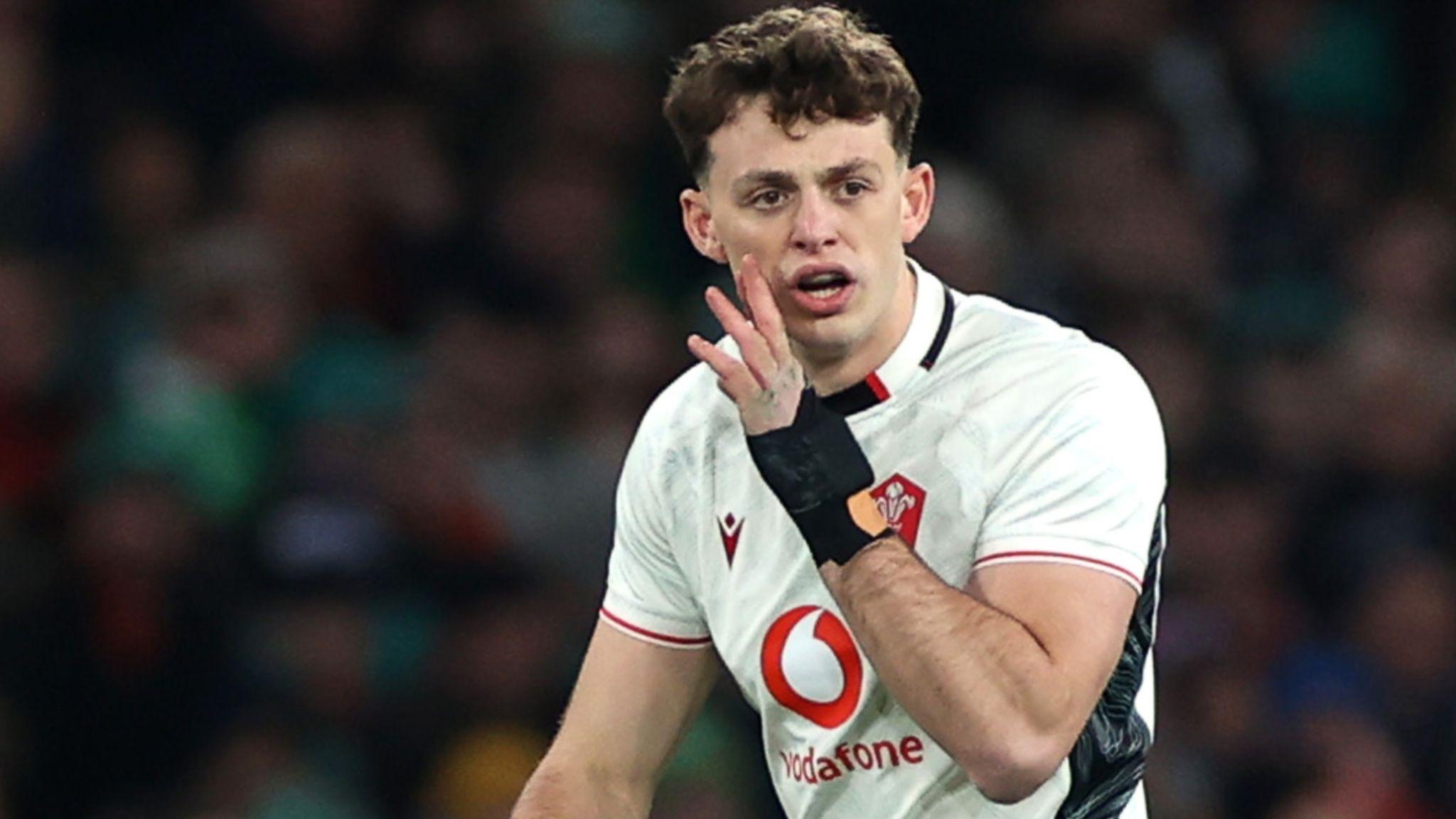 Louie Hennessey shouts with hand to mouth during a Wales game