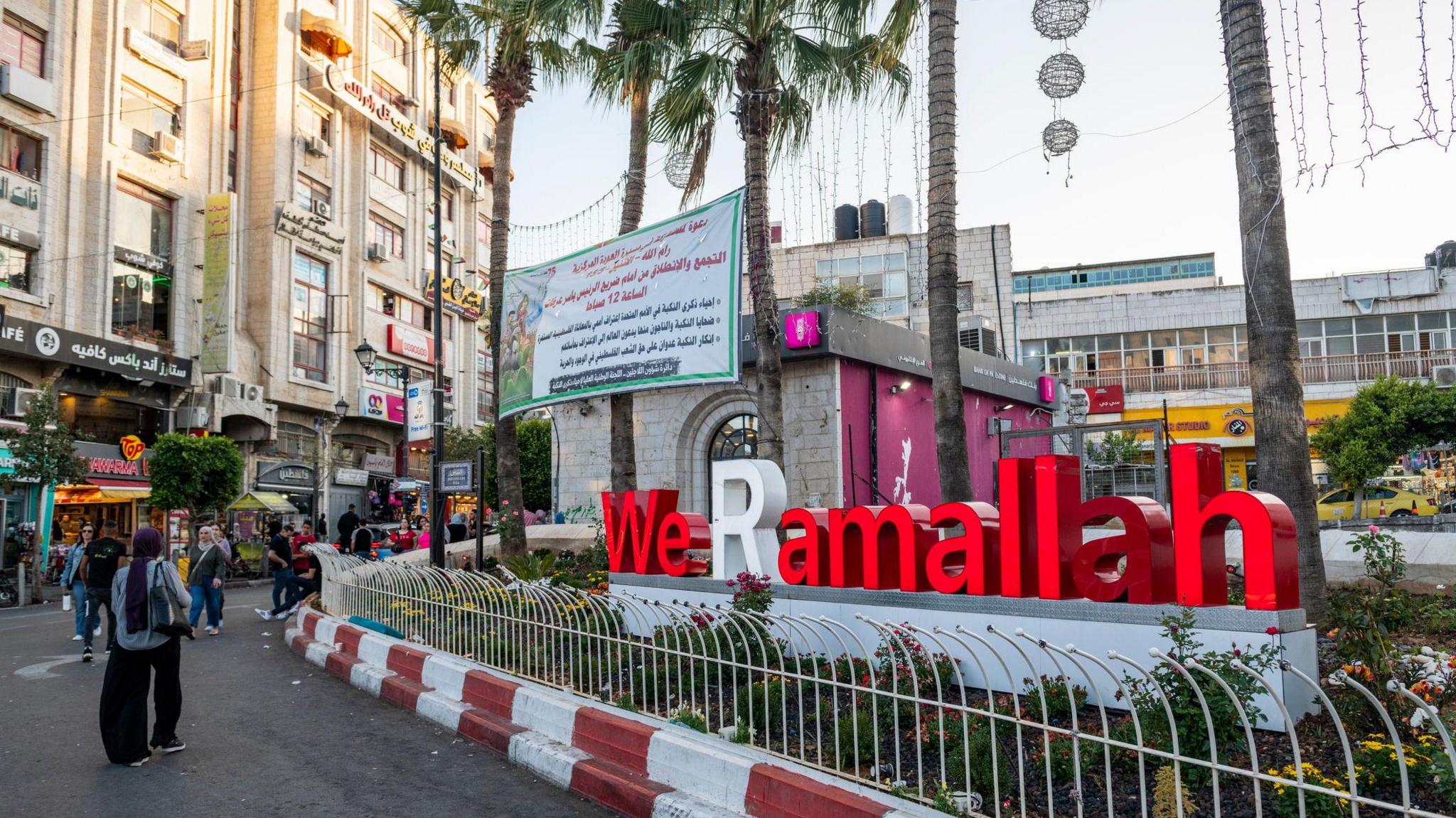 In the center of the West Bank city of Ramallah, a display reads We Ramallah.